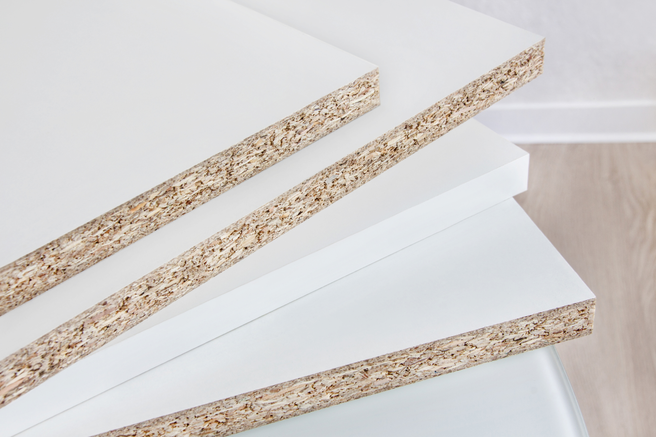 Four Pieces of White Plastic on Particleboard, for a Piece of Household Furniture, in a Room