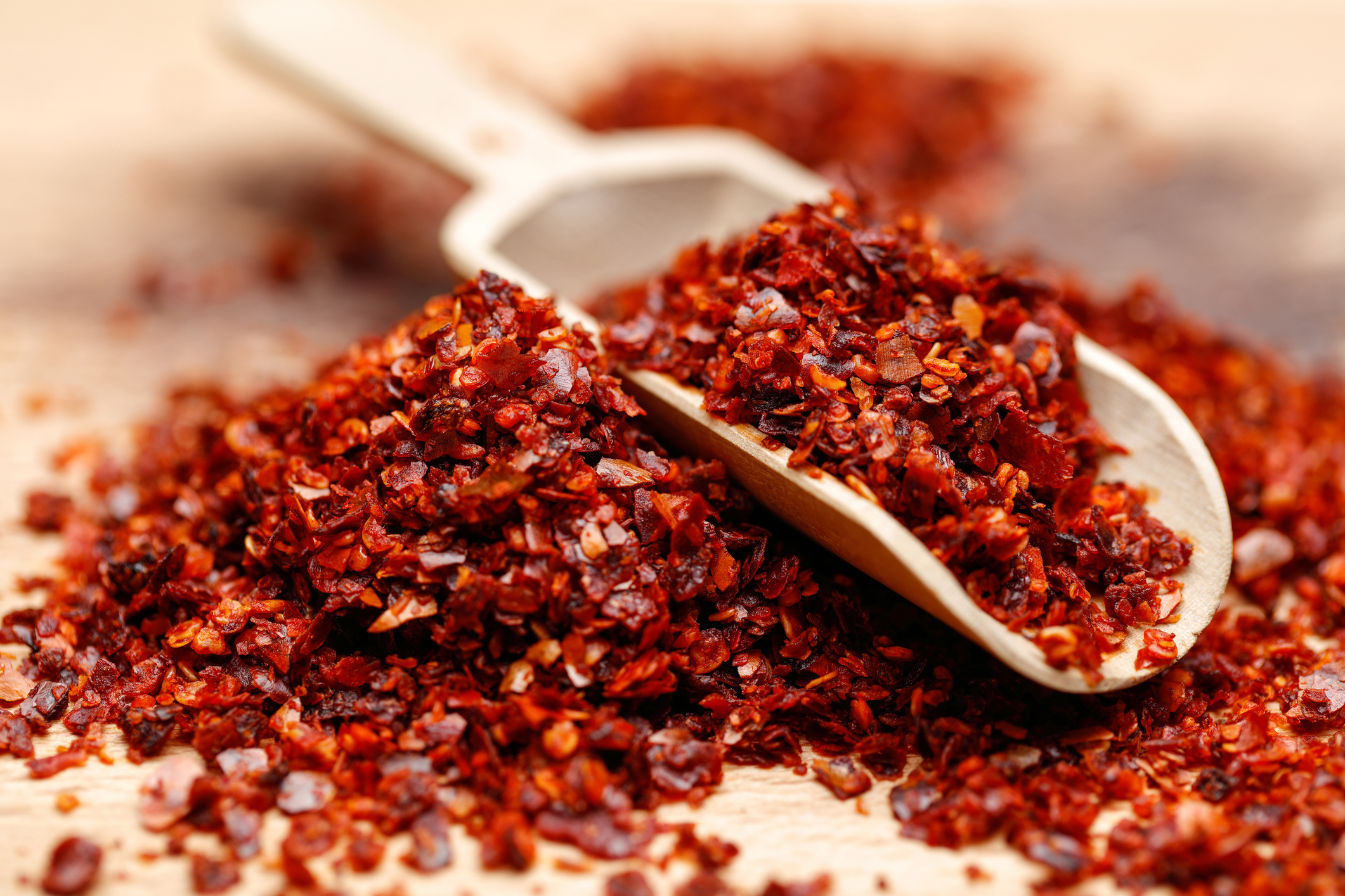 Closeup of Ground Red Pepper and Seeds With a Scoop, Selective Focus