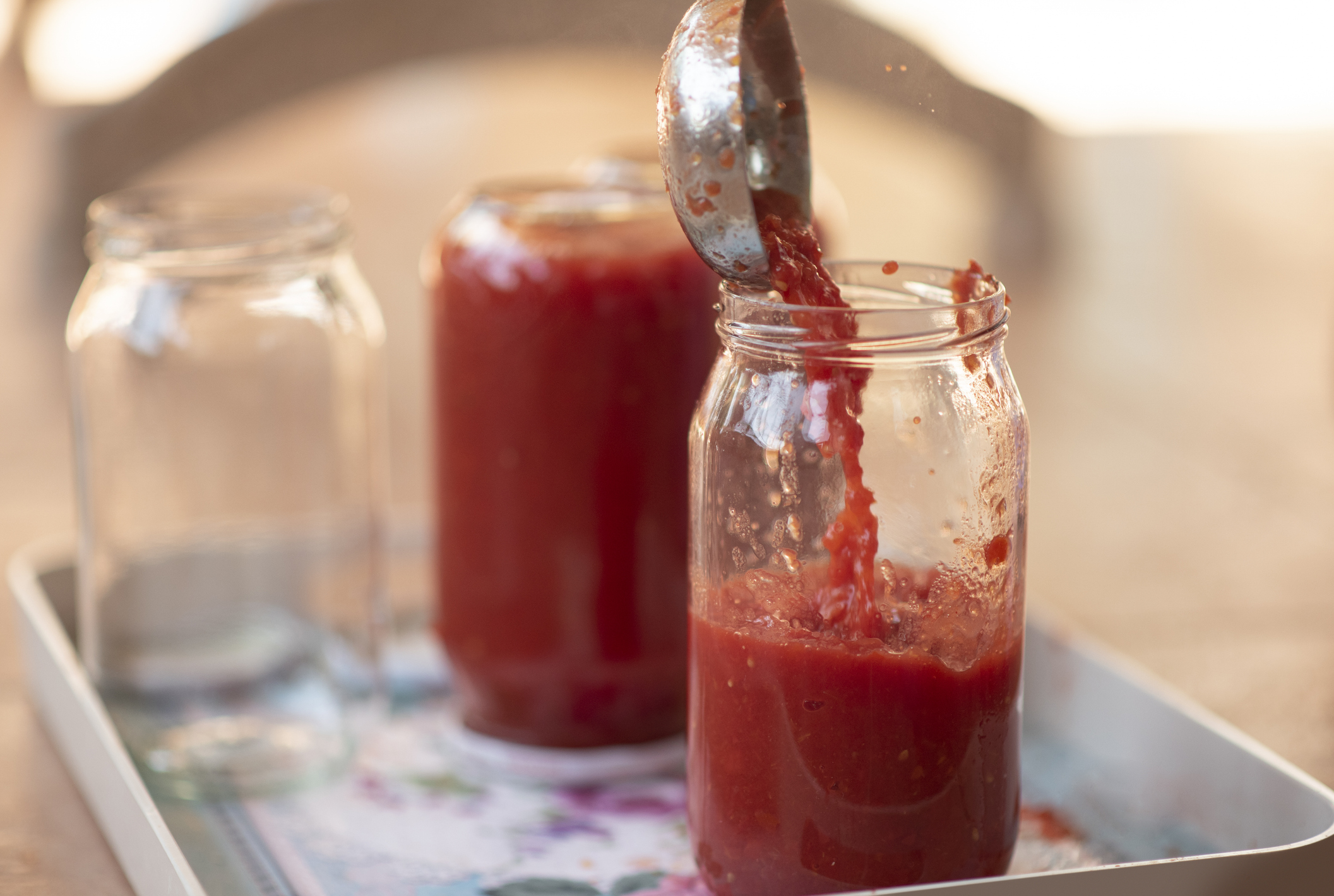 Pouring Tomato Sauce Into Cans for Preserving