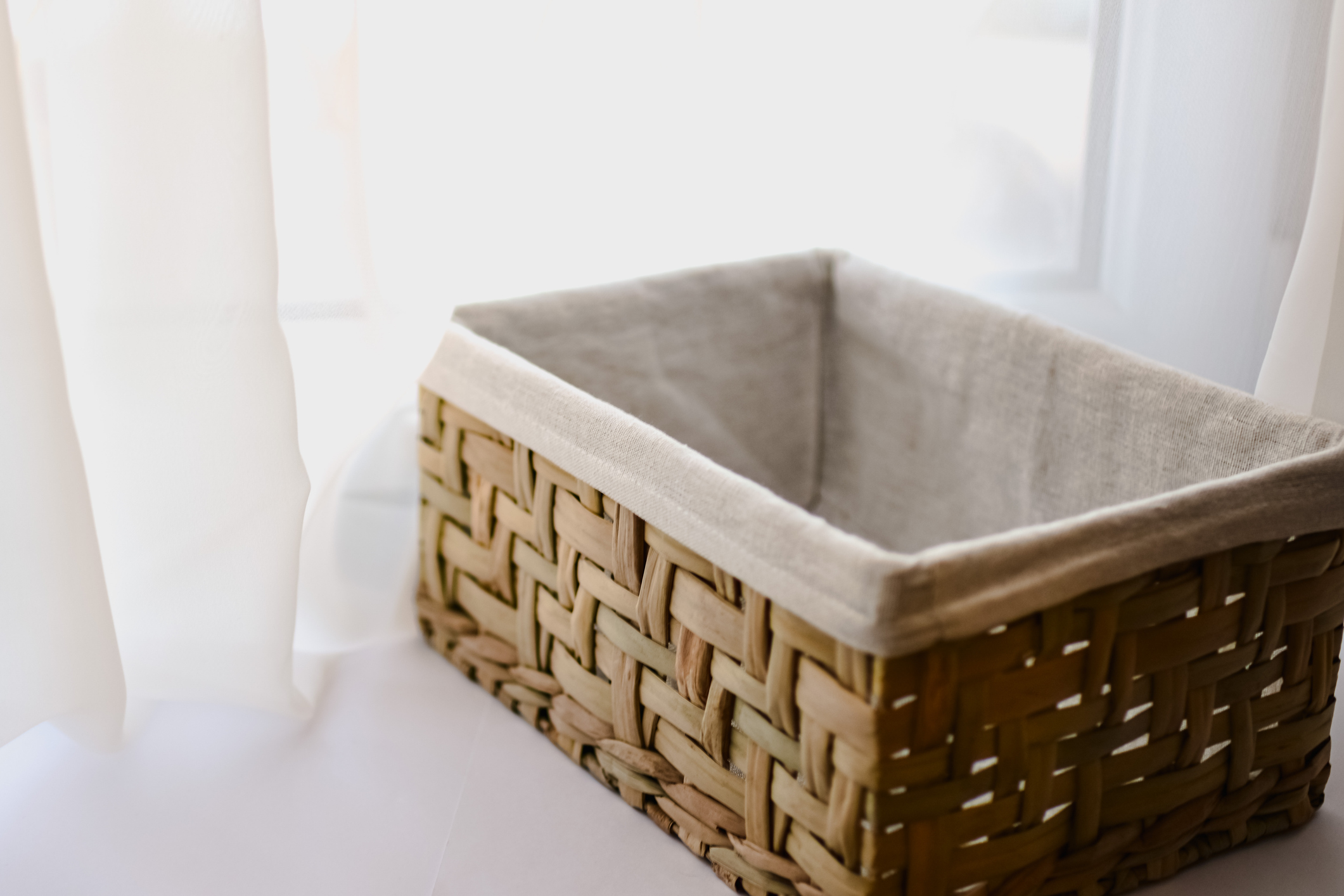 Empty Organizing Basket on Window Ledge in Home, White Background
