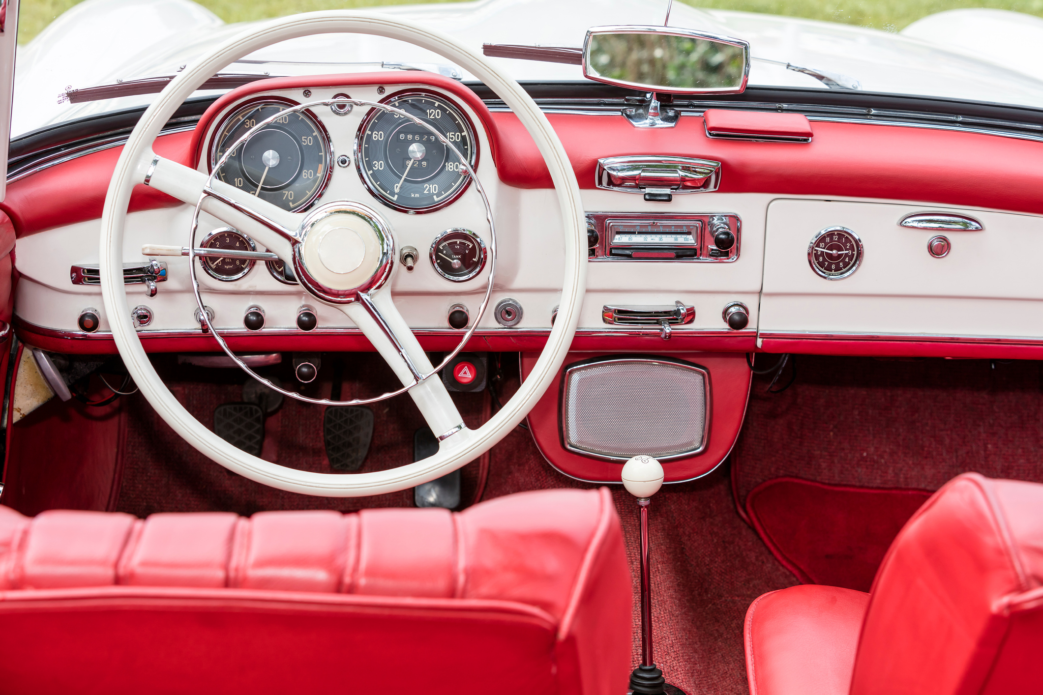 Red and White Leather Dashboard and Steering Wheel, Front Interior, of a Vintage Convertible Car