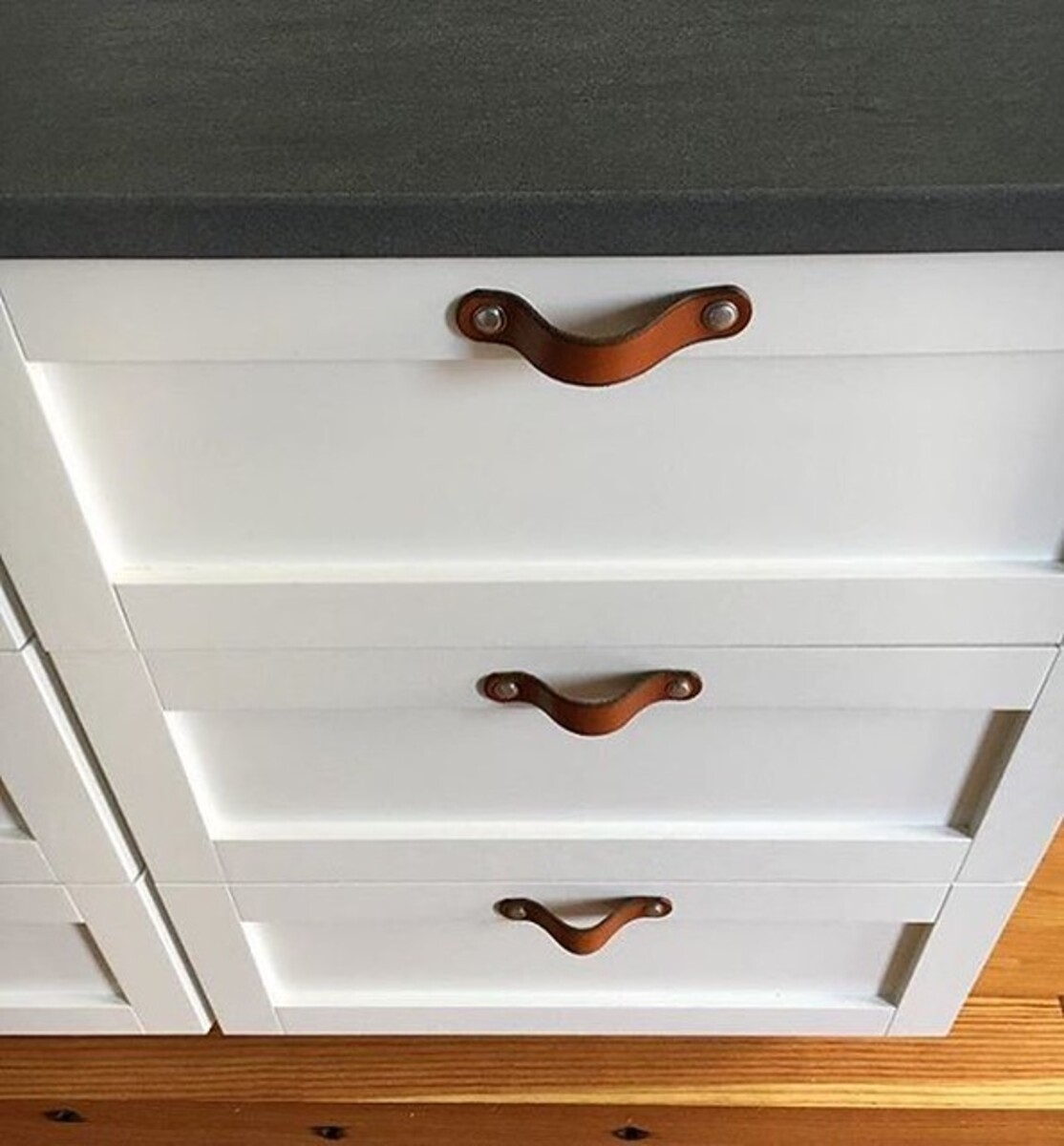 Brown Leather Cabinet Knobs on White Cabinets in Kitchen