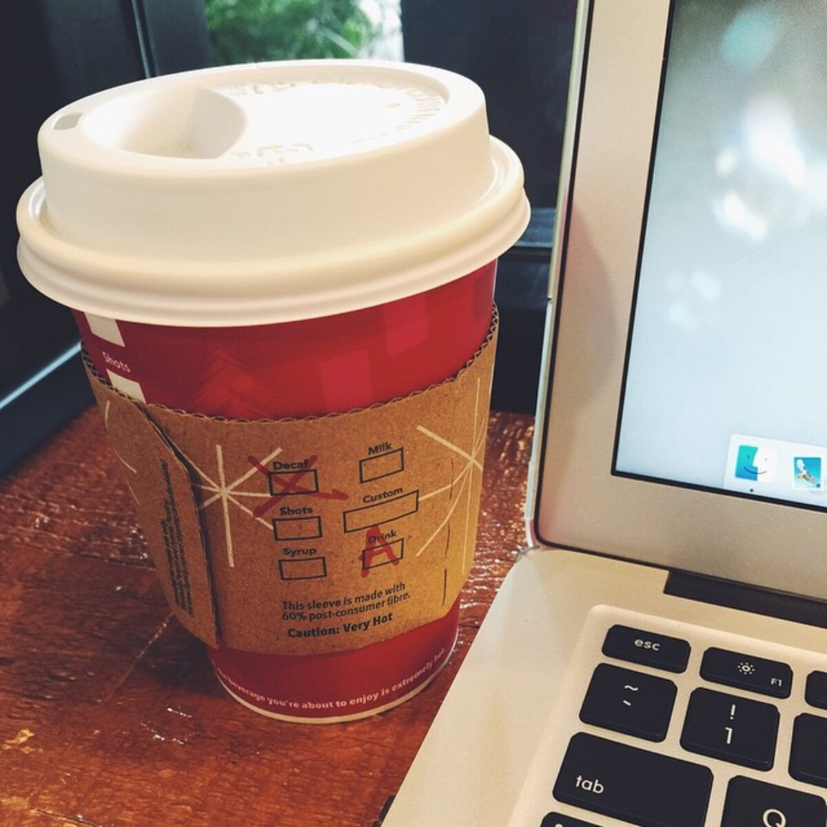 Decaf Tall Starbucks Americano Next to a MacBook, During the Holidays