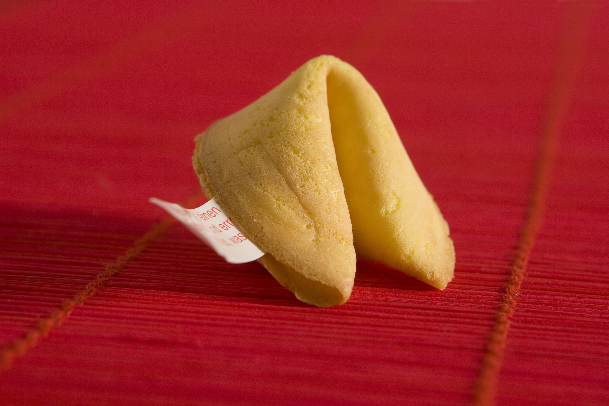 a fortune cookie against a red backdrop