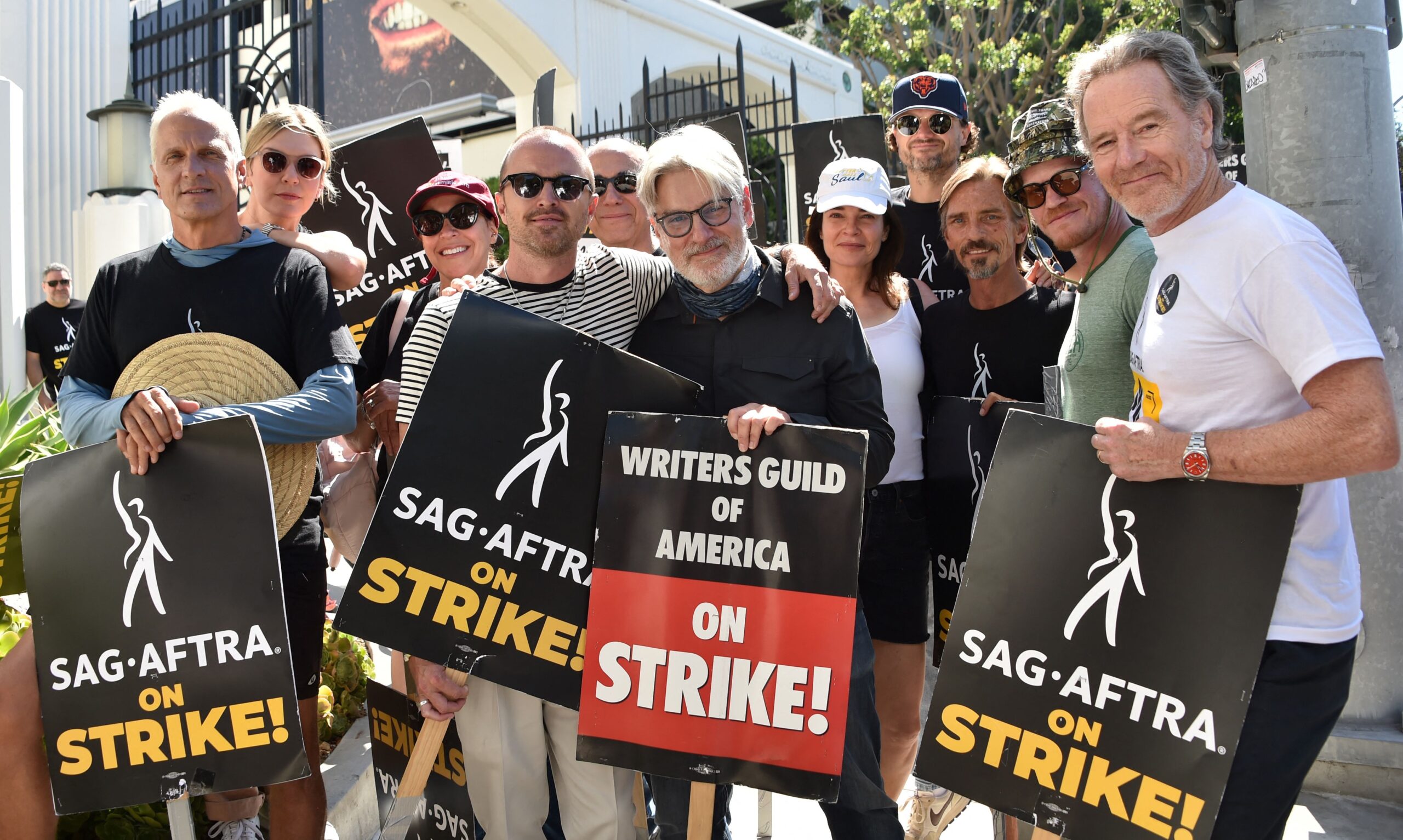 Actors (L-R) Patrick Fabian, Rhea Seehorn, Norma Maldonado, Aaron Paul, writer Peter Gould, Betsy Brandt, Matt Jones, Charles Baker, Jesse Plemons and Bryan Cranston join members of the Screen Actors Guild (SAG-AFTRA) and WGA on the picket line in front o
