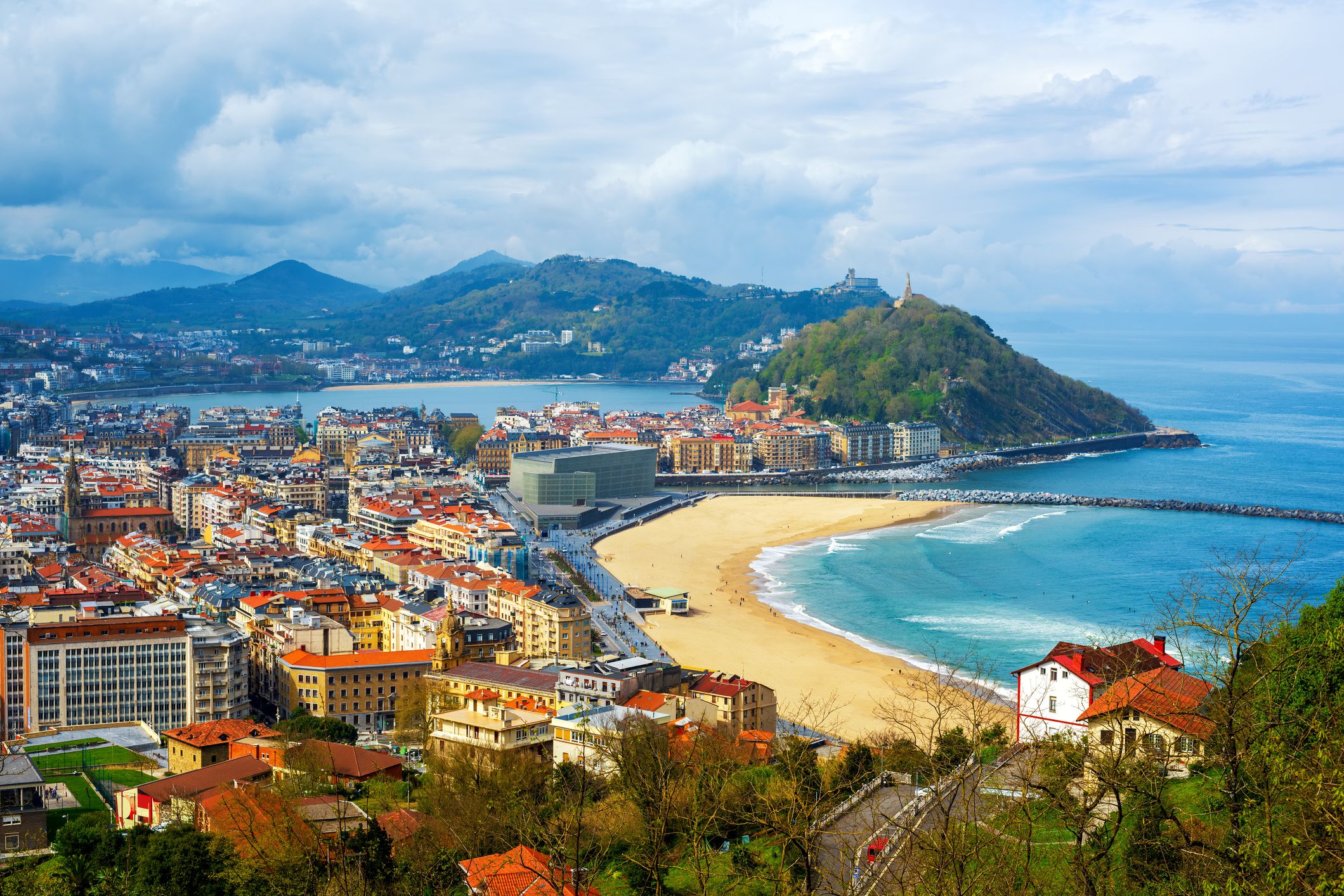 San Sebastian - Donostia city, Basque country, Spain, view of the Zurriola beach, Urgull mount, La Concha bay, surrounding Pyrenees mountains and Atlantic ocean