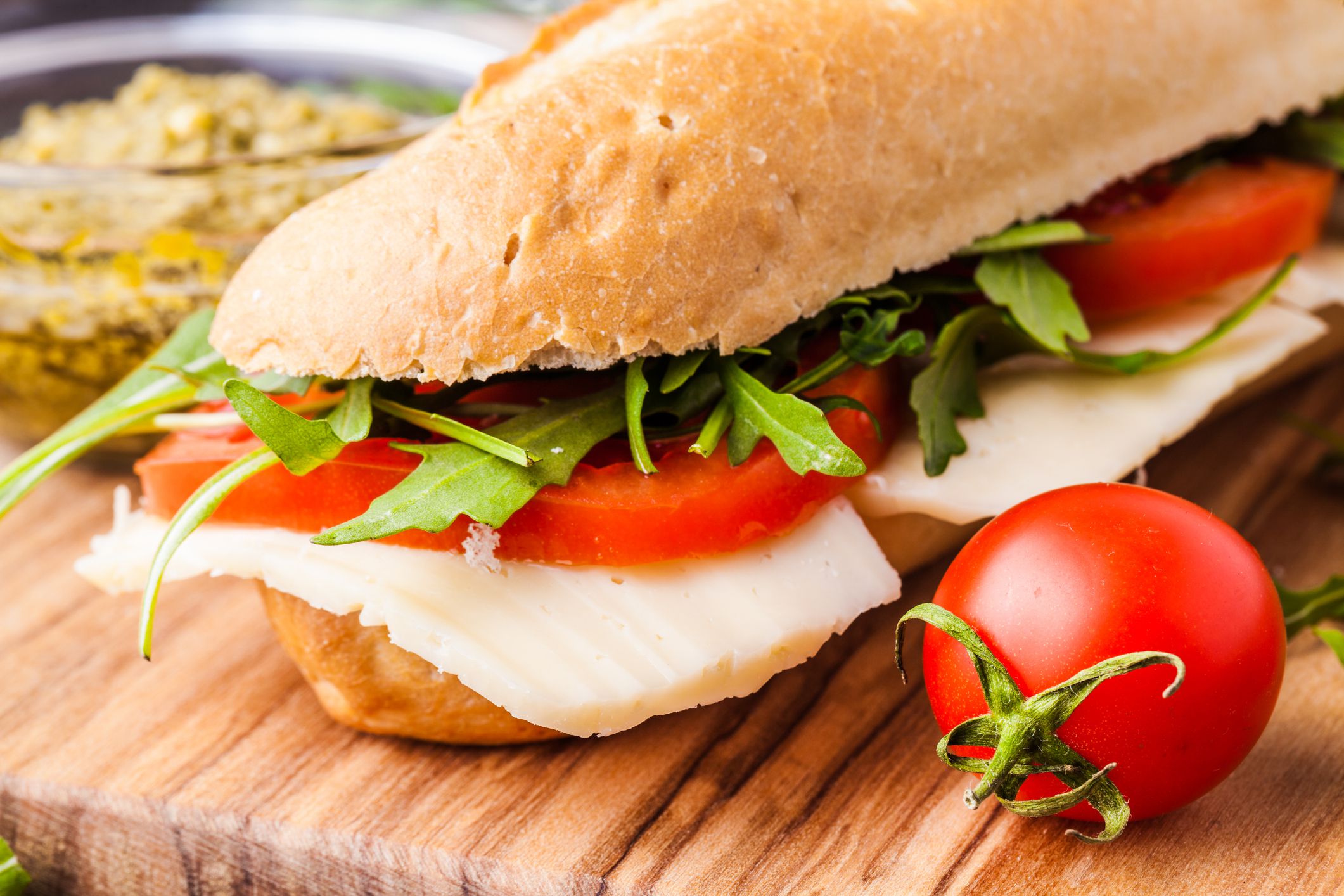 Close up of freshly made sandwich on wooden cutting board
