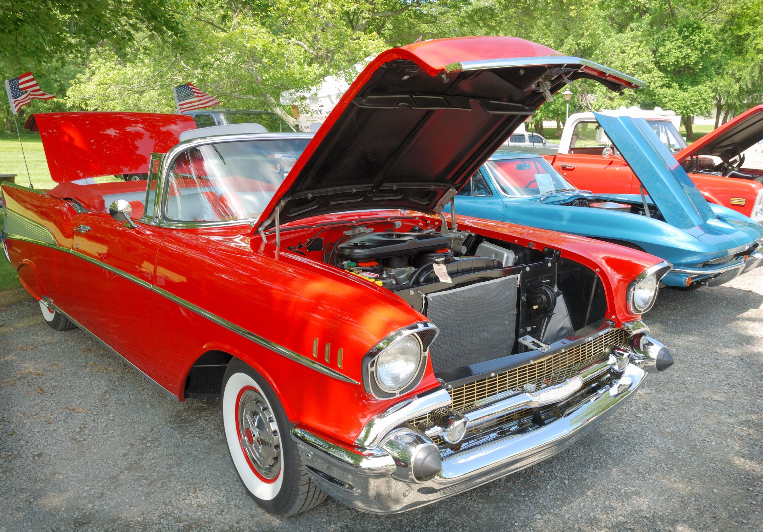 Vintage American muscle car with hood up and engine visible. Antique collector's car.