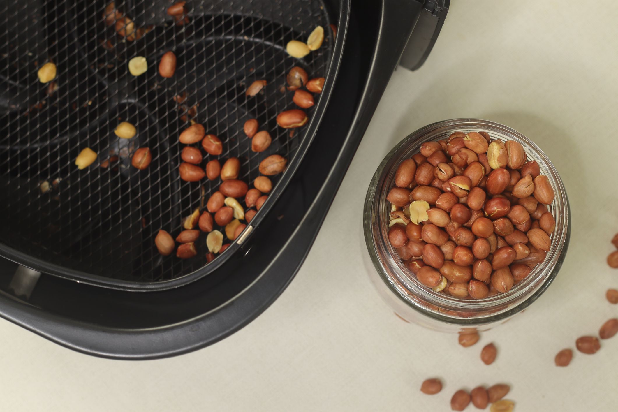 Roasted groundnuts. Peanuts roasted with air fryer. Air fried groundnuts are oil free preparation for a healthy evening snack. Shot along with air fryer pan