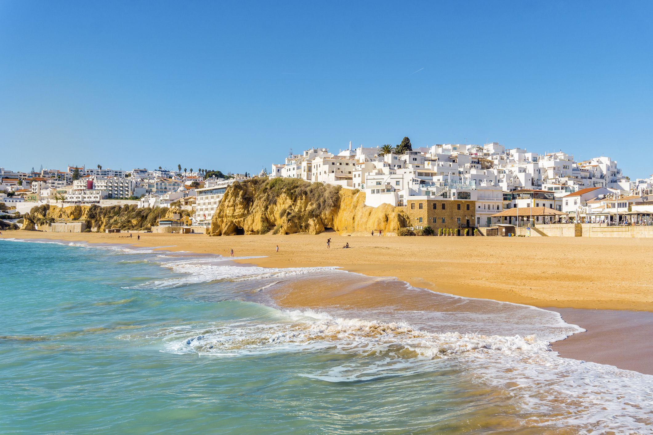 Wide, sandy beach in white city of Albufeira by Atlantic Ocean, Algarve, Portugal