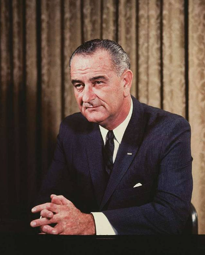 Photo of President Johnson sitting at a desk