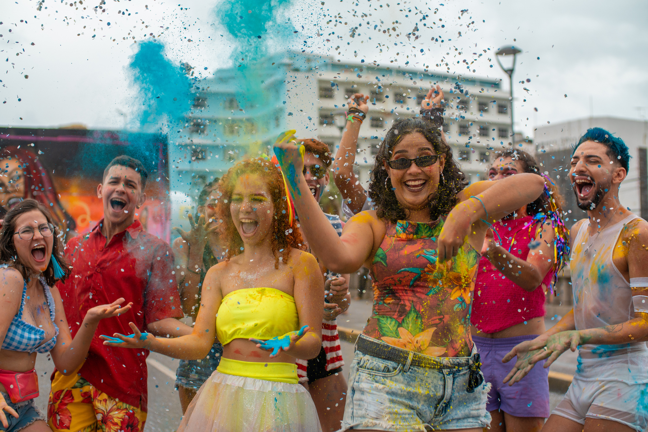 Diverse Group of Young 20s People Celebrating Holi on Rooftop in a City