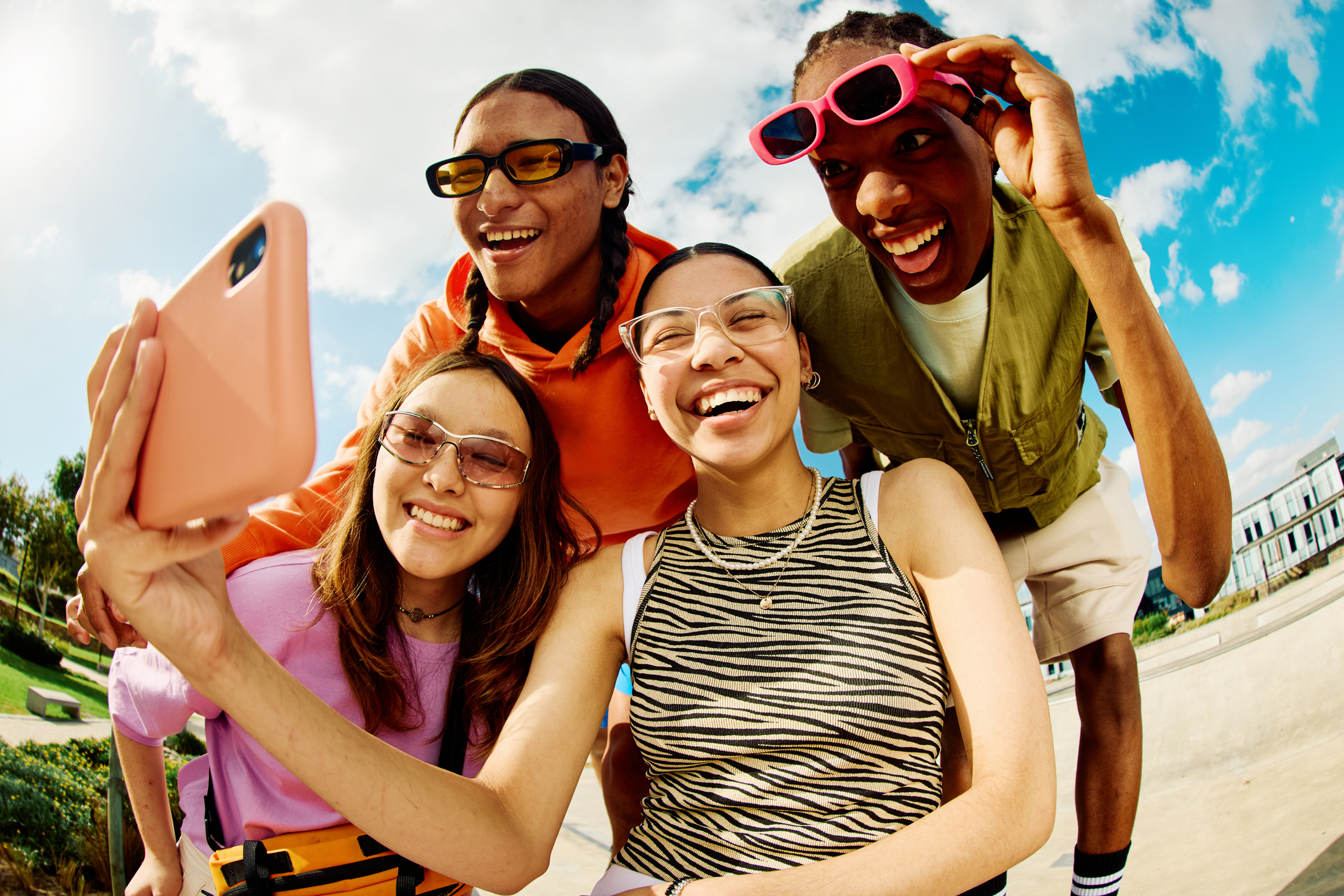 Four Happy College Students Taking a Selfie With a Smartphone, Outside