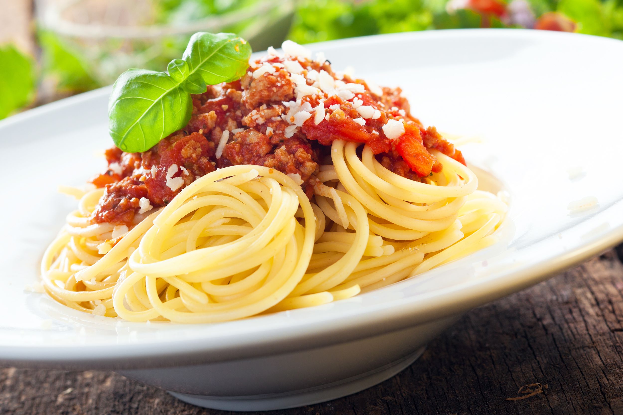 Spaghetti with Meat Sauce garnished with fresh basil