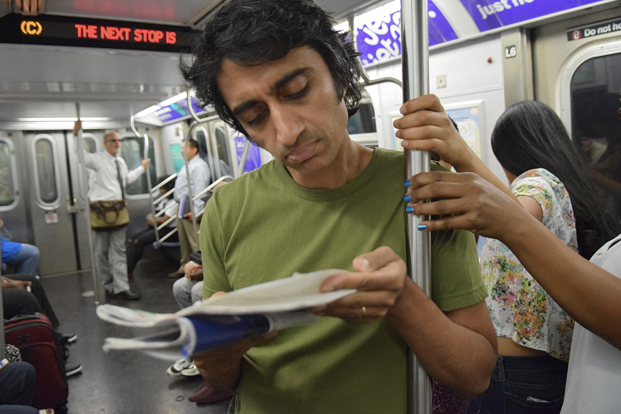 Man hogging the subway pole in NYC