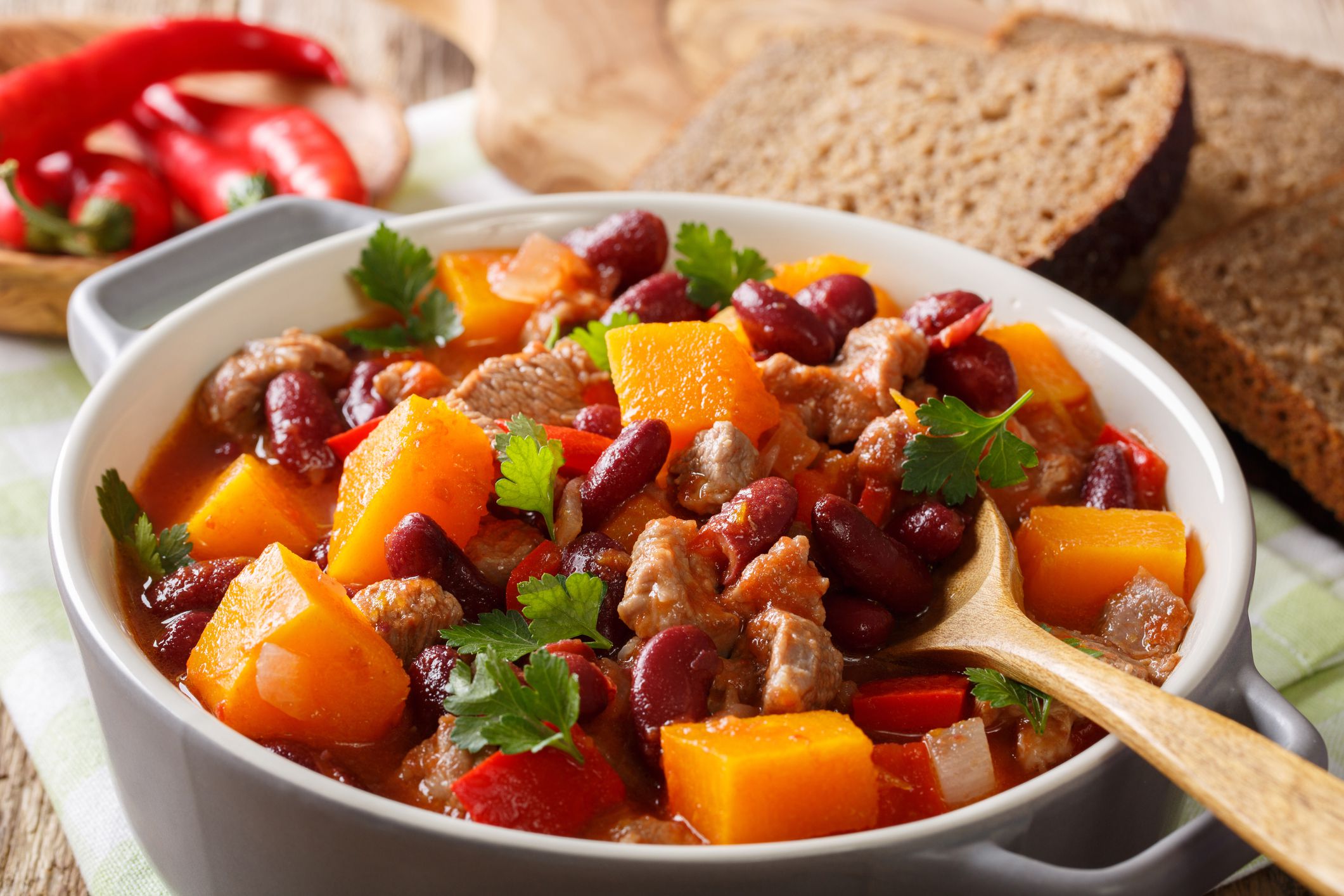 delicious pumpkin stewed with meat and vegetables close-up in a saucepan on a table. horizontal