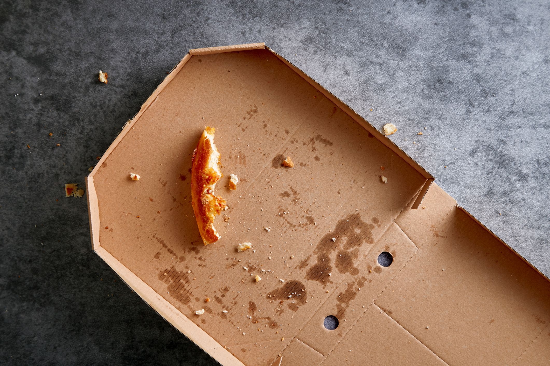 Pizza box with leftowers. Empty pizza cardboard box viewed from above. Top view.