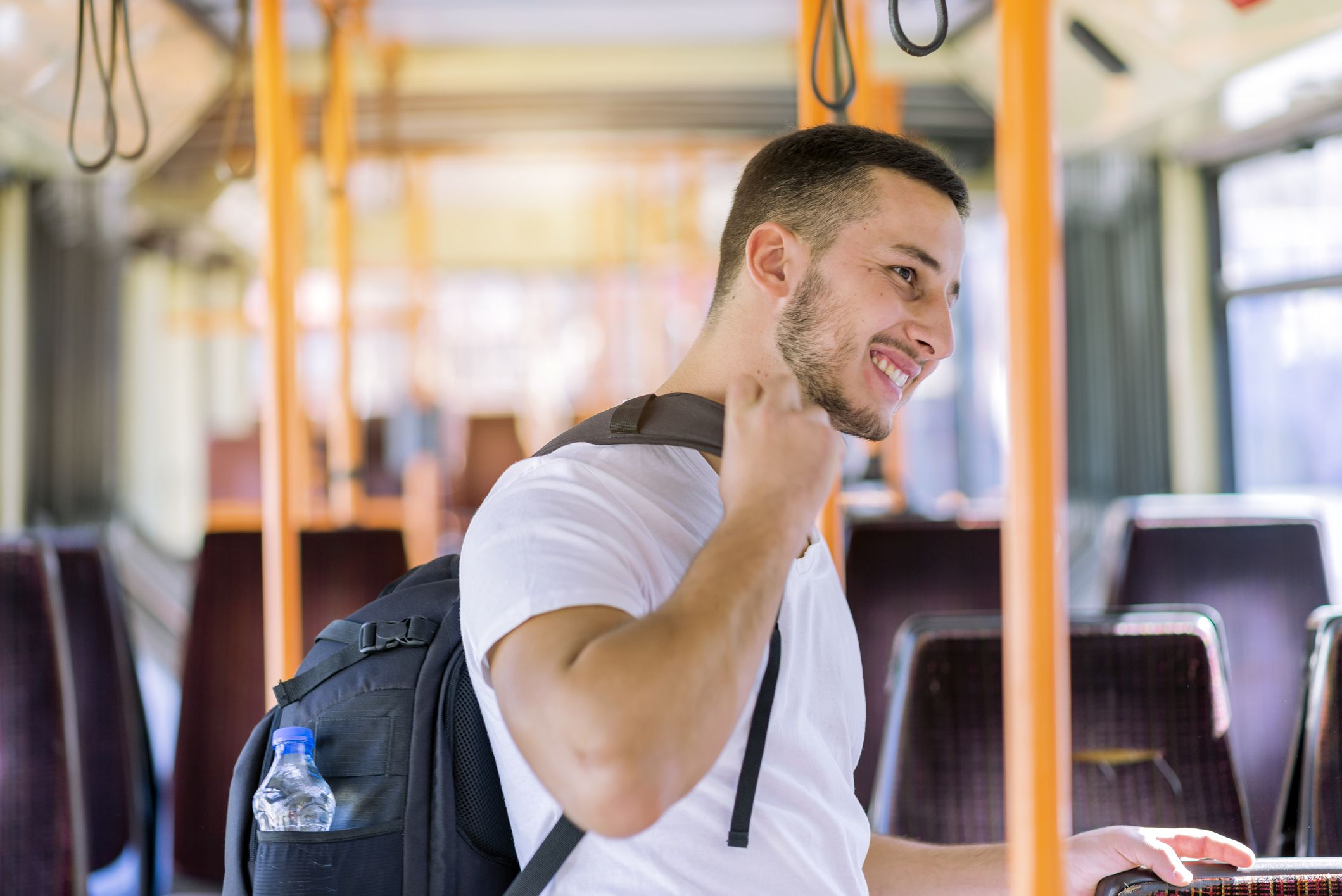 Handsome Tourist with Backpack and Toothy Smile Enjoy to Travel With Bus