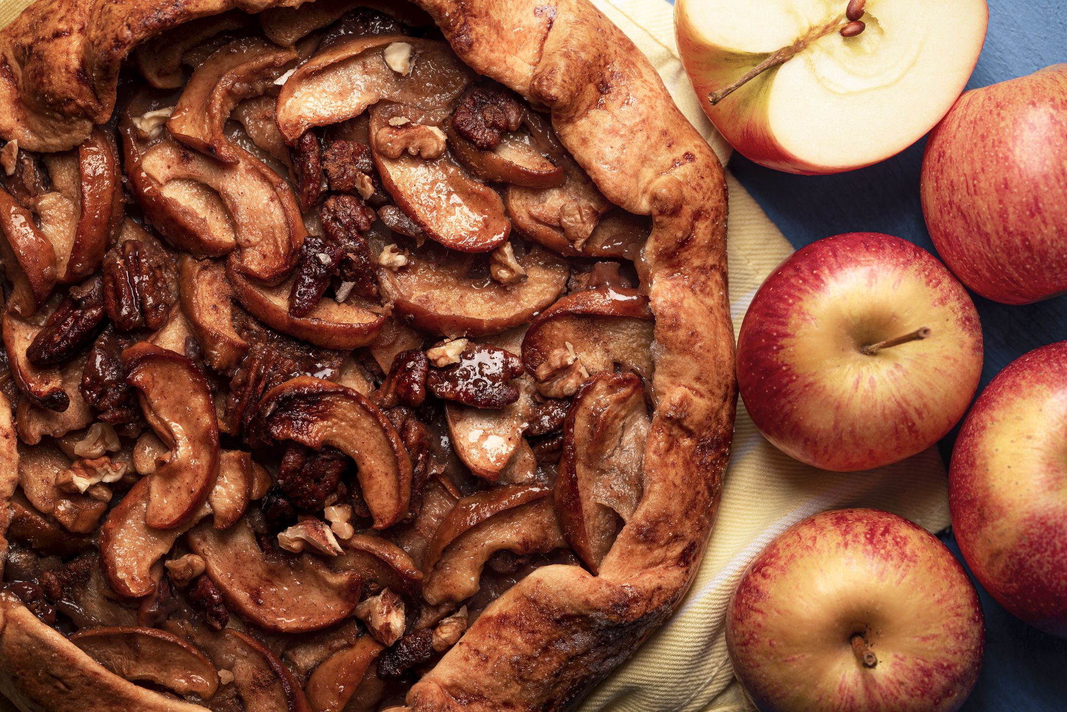 Apple pie with crunchy pecan nuts and delicious crust above view. Apple galette close-up