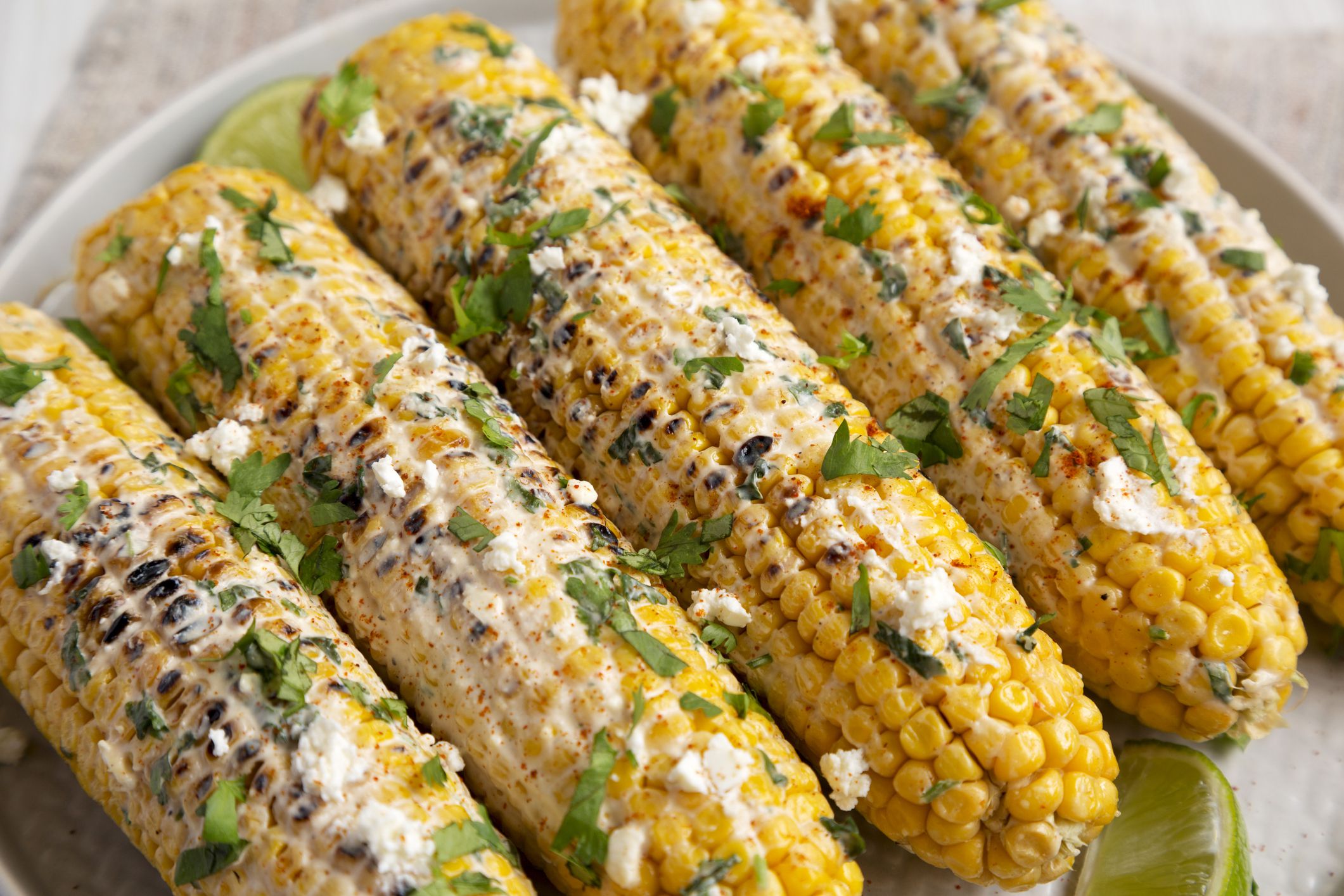 Homemade Elote Mexican Street Corn on a plate, side view. Close-up.