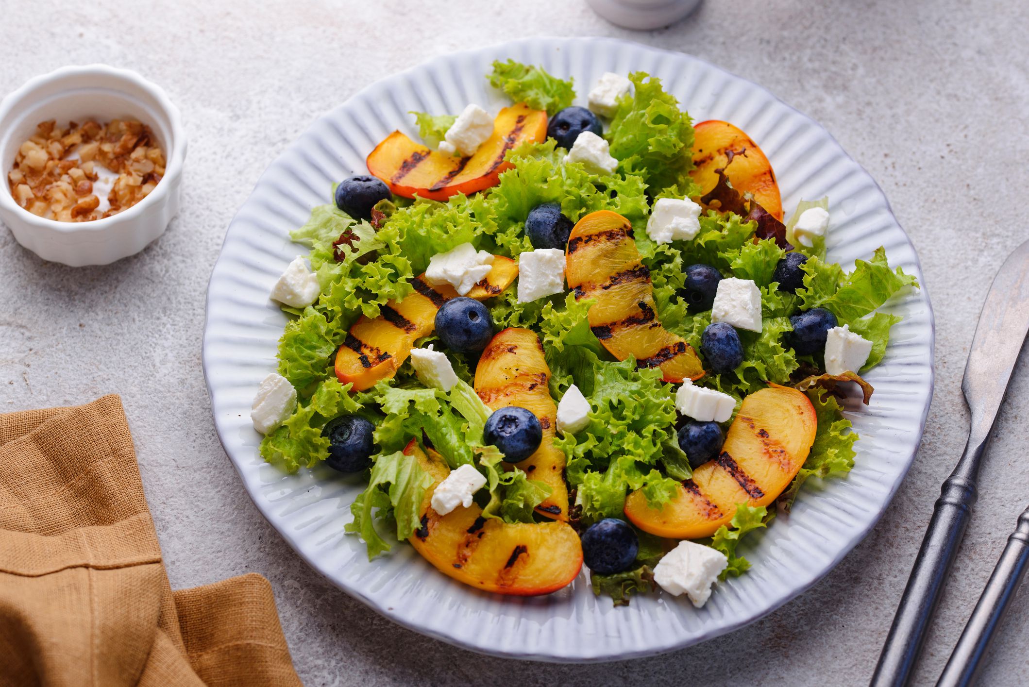 Summer salad with grilled peach, blueberry and feta cheese