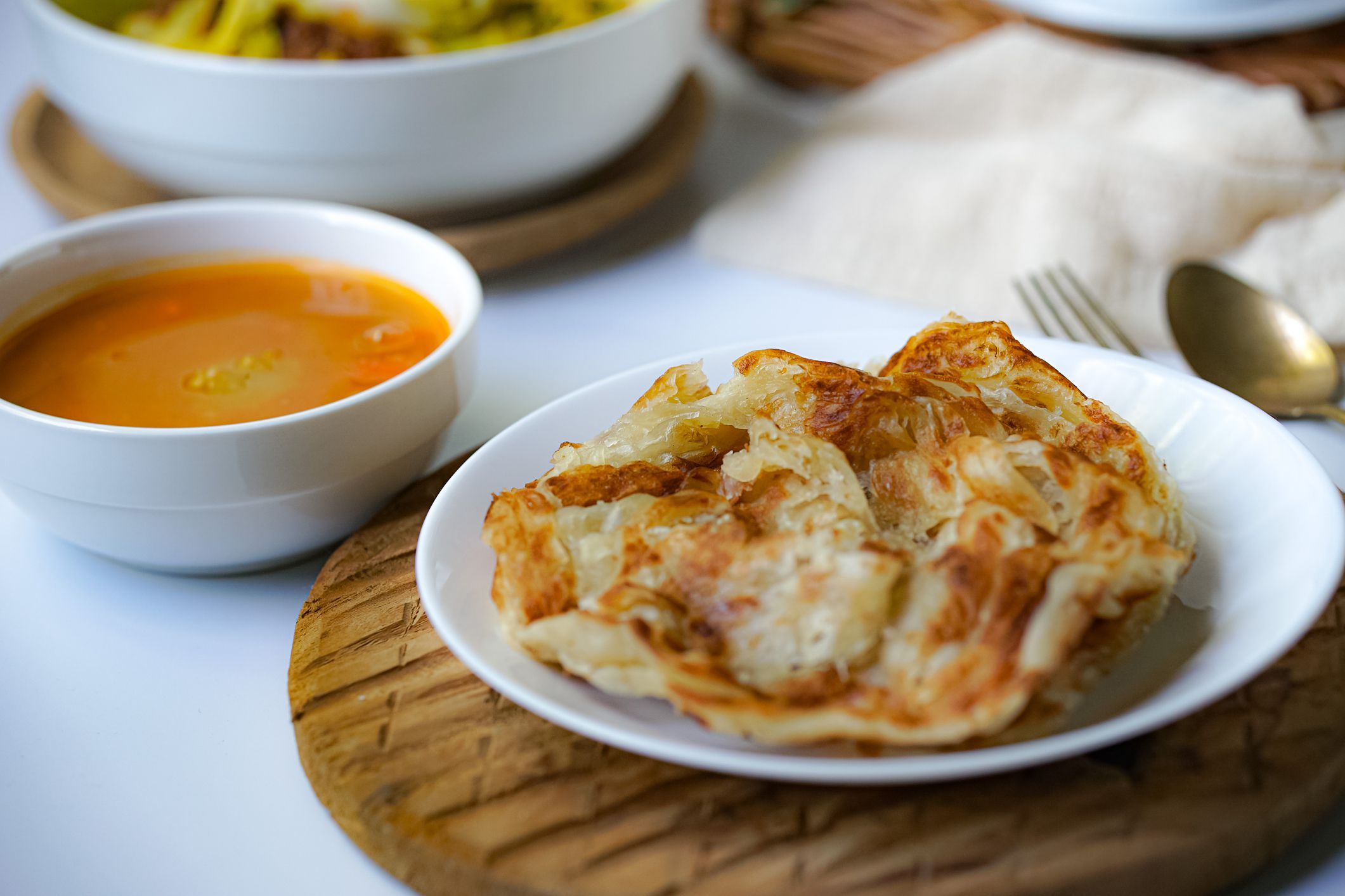 Roti Paratha or Roti Canai with curry sauce, a popular Malaysian breakfast