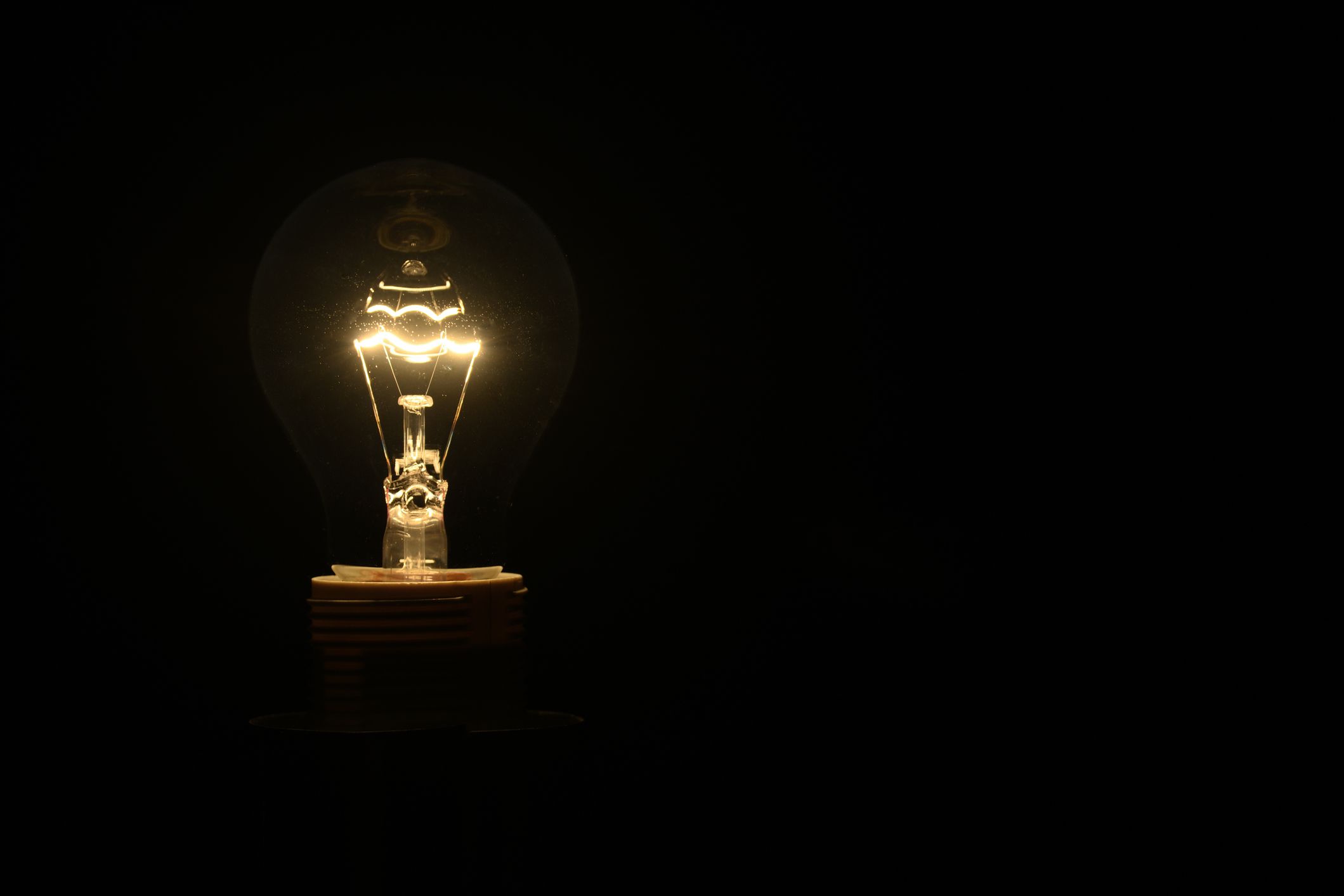 Vintage incandescent bulb emits warm, nostalgic glow with timeless charm.