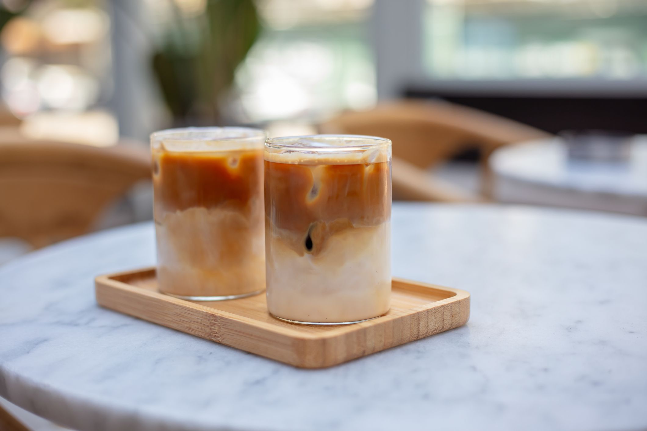 Two glasses of iced coffee on the cafe table.