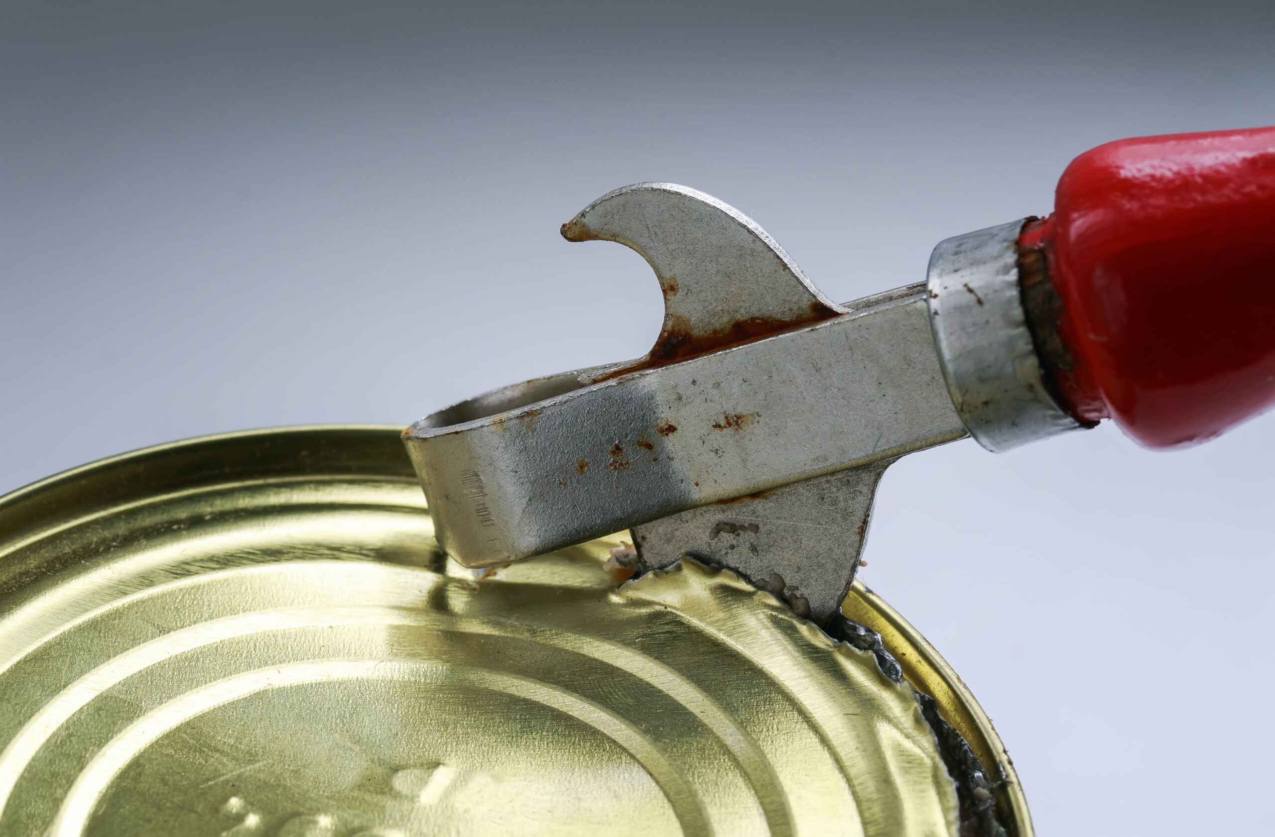 old rusty metal knife opens a metal tin