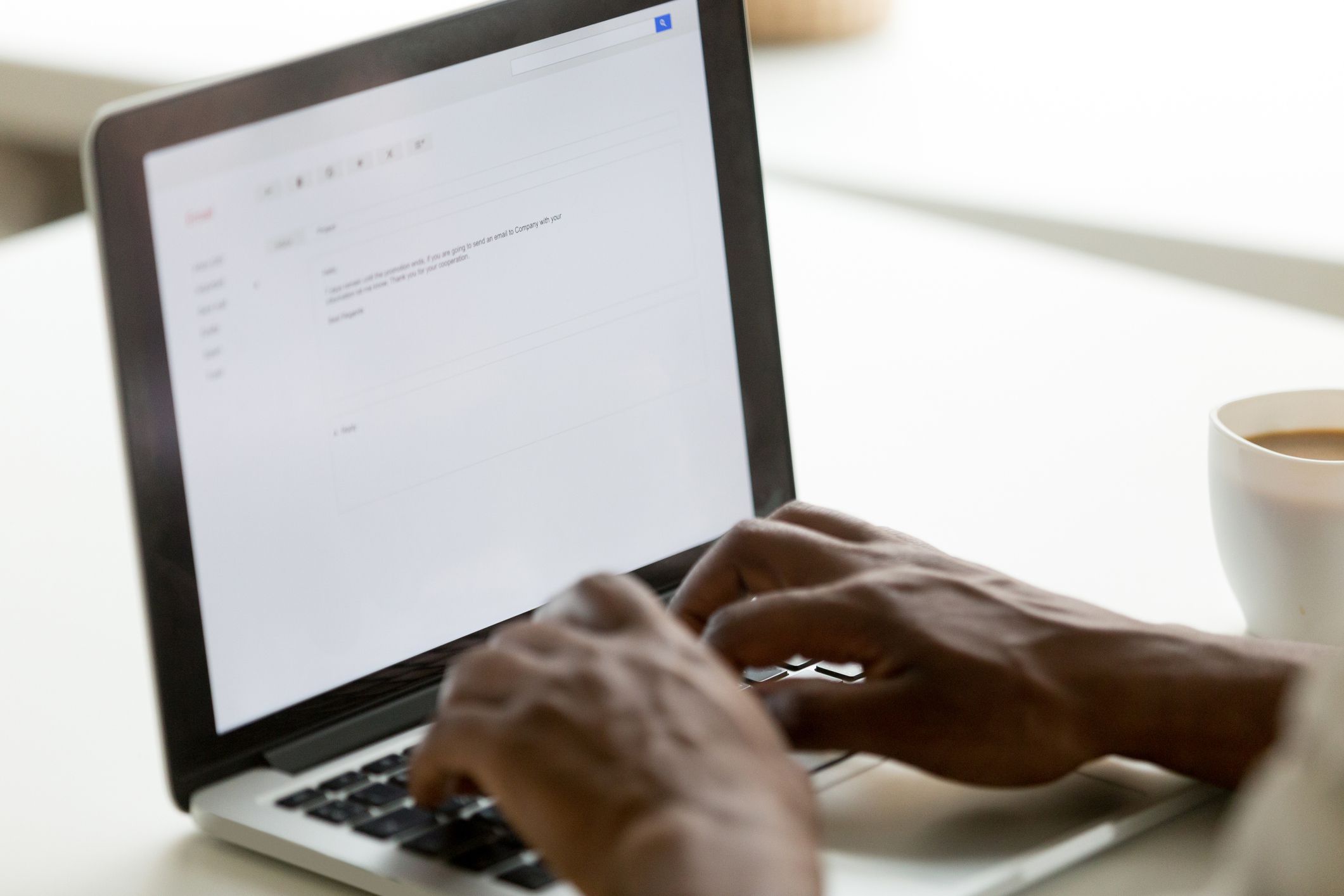 African businessman typing e-mail on laptop using online application pc software, black man mailing client writing e letter on computer screen, business correspondence concept, close up rear view