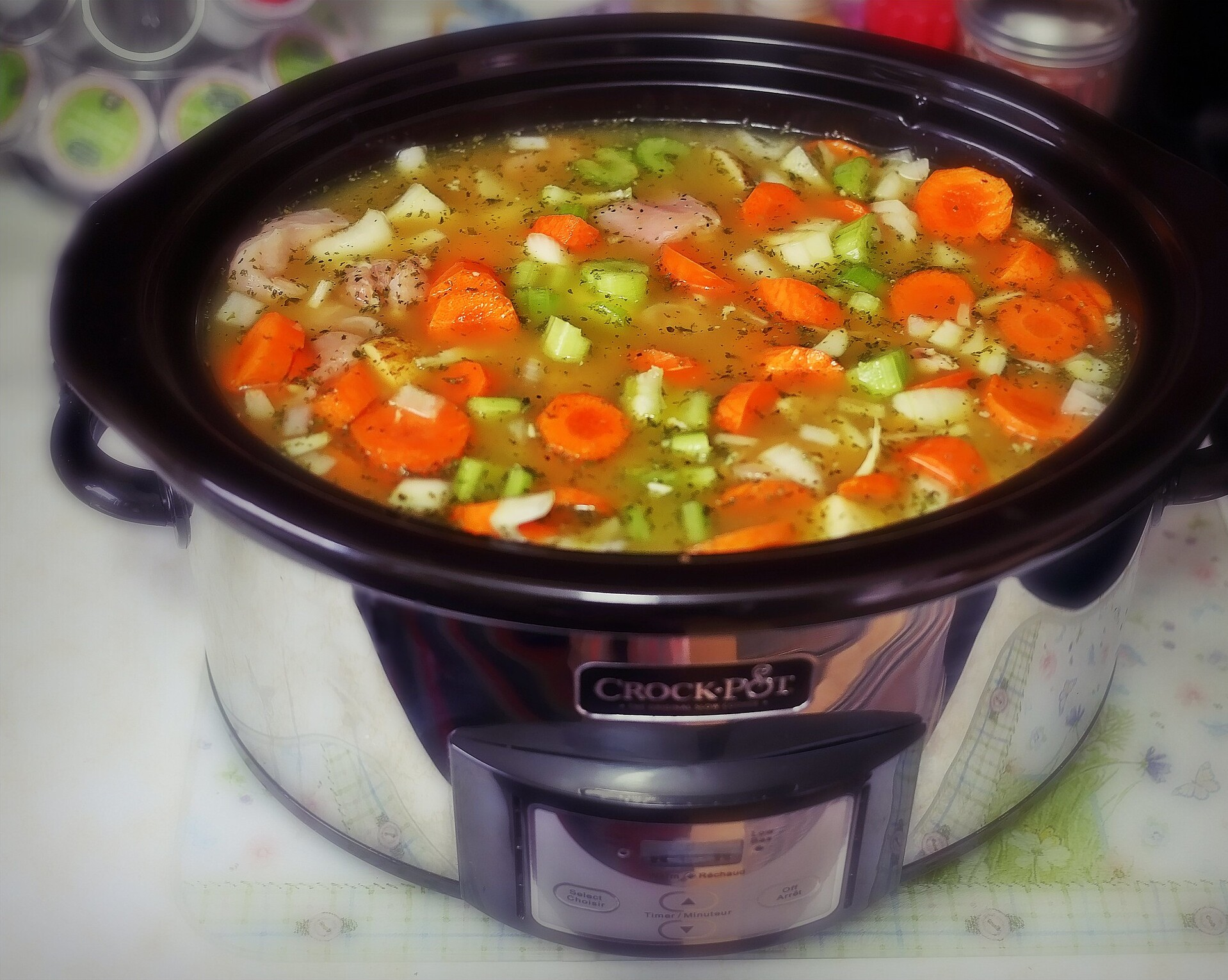 Homemade Chicken Soup in a Crockpot on a Kitchen Countertop, Selective Focus