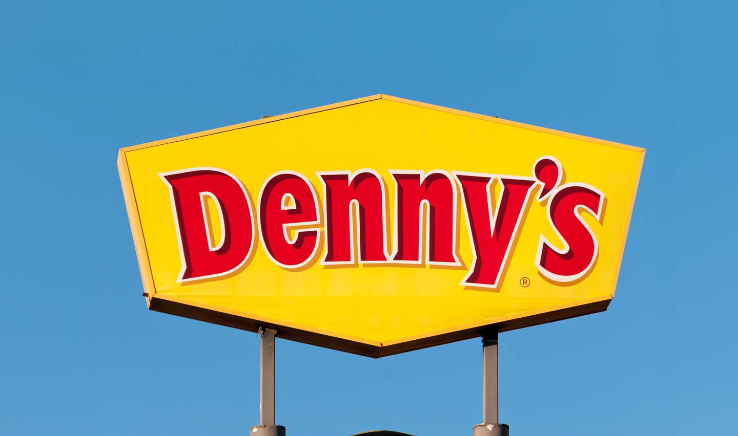 Denny's restaurant sign against a clear, blue sky in West Pam Beach, Florida