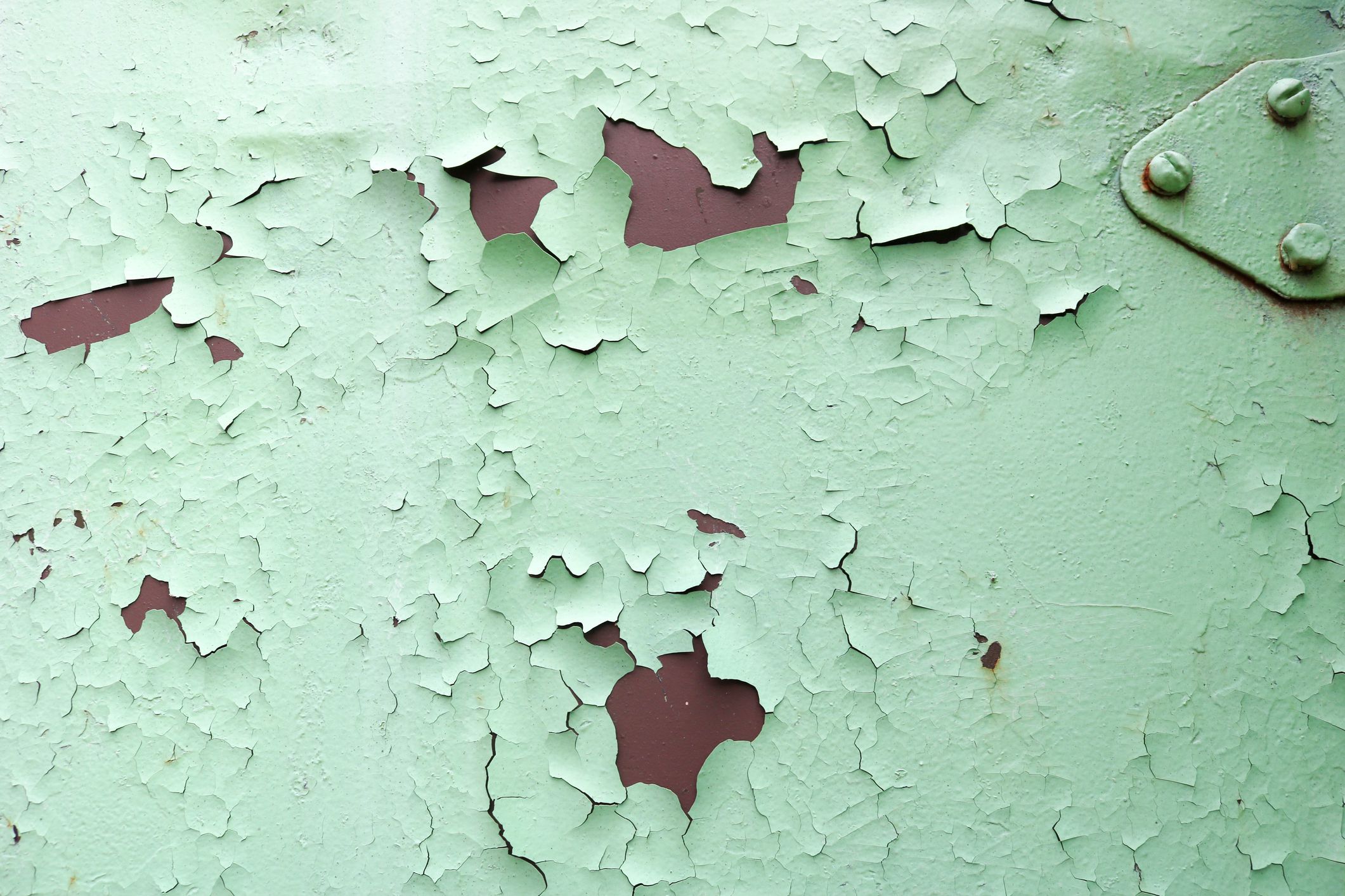 Texture of rusty two-color reddish and green old shabby oxidized metal, iron with bulbted peeling and green paint and patterns, background.