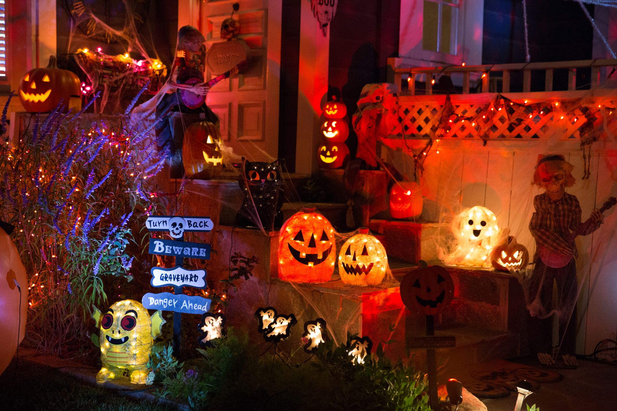 A house with Halloween pumpkins and halloween decorations at Halloween night on a city street. Trick or treat.