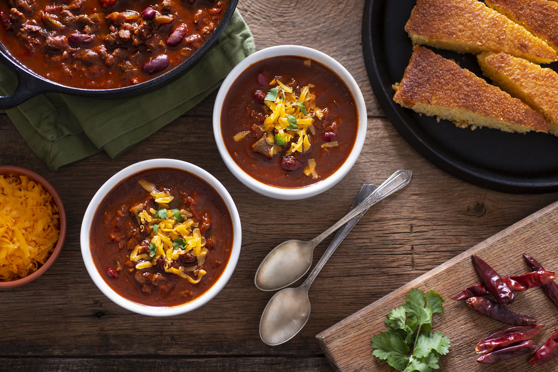 Bowls of Homemade Chili with Corn Bread, Cilantro and Cheddar Cheese