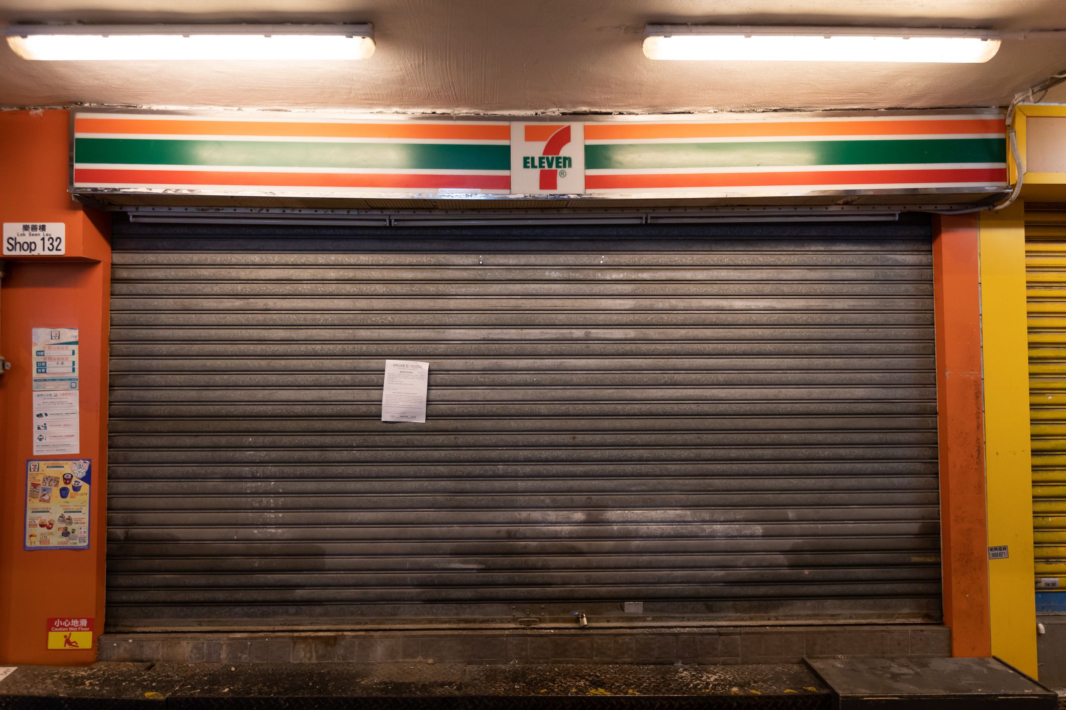 Hong Kong - February 26, 2022 : 7-Eleven Convenience Store closed due to a close contact of a COVID-19 case in Kowloon, Hong Kong.