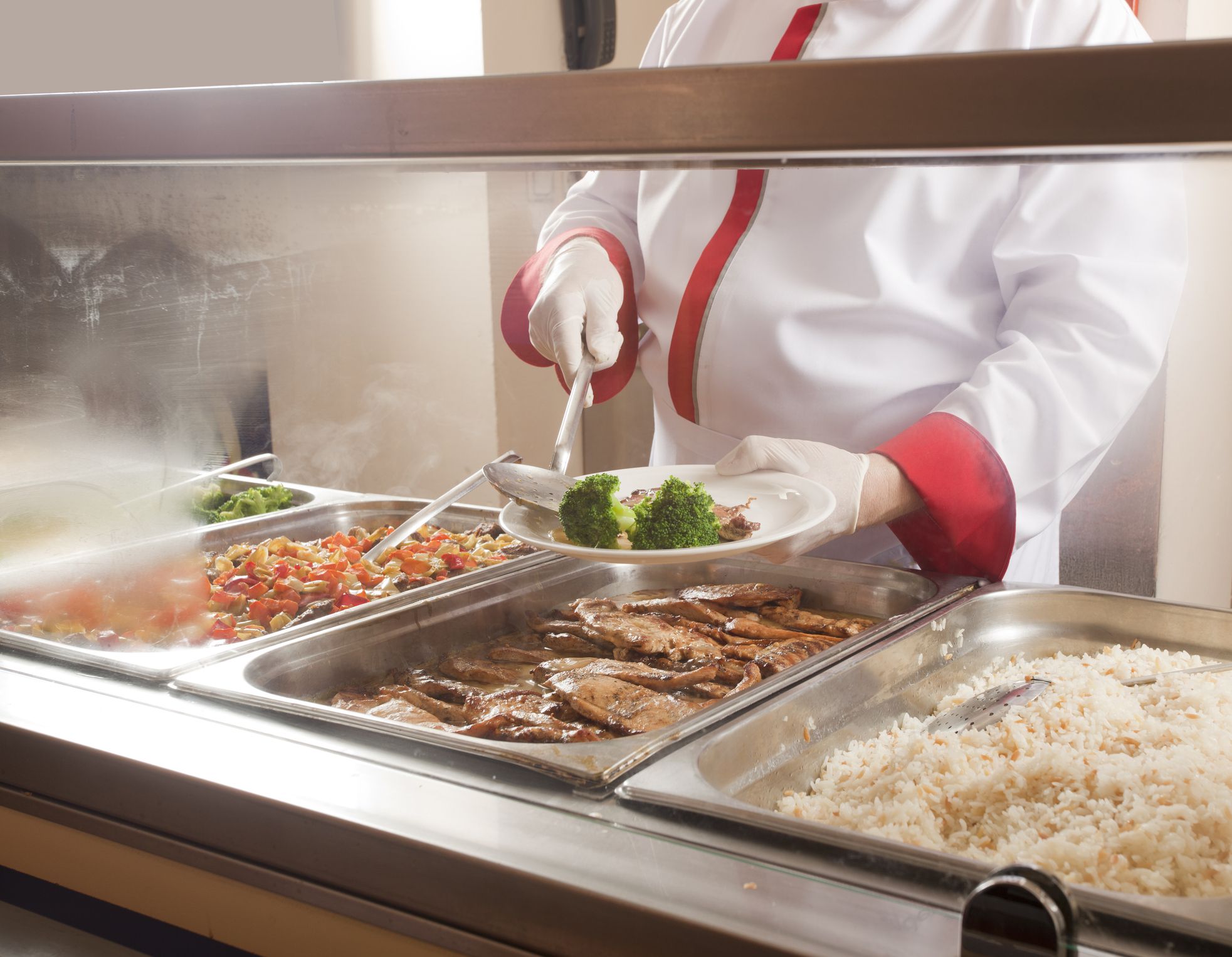 chef standing behind full lunch service station