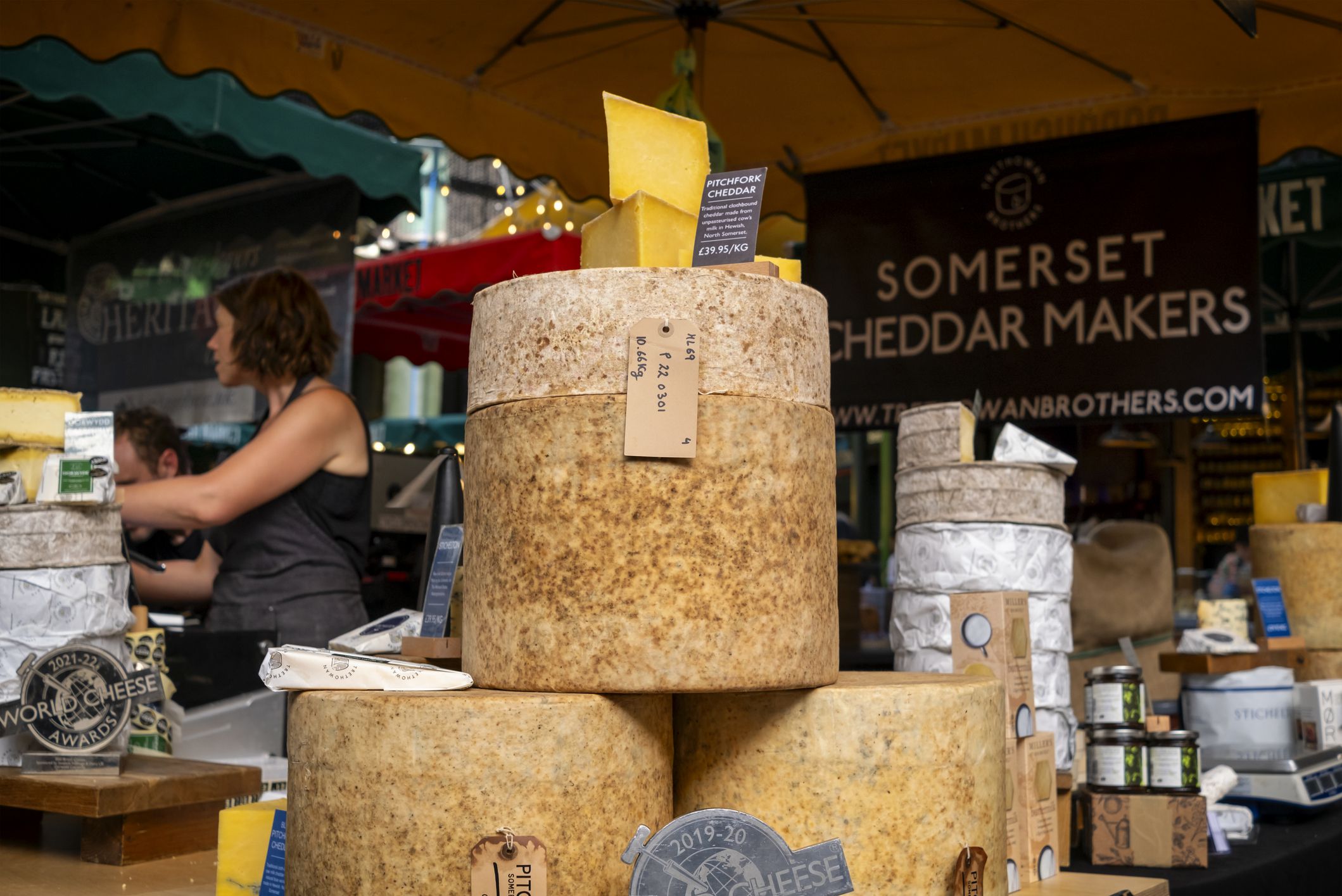 Stacks of cheeses on a stall in Borough Market, in Southwark, South East London.