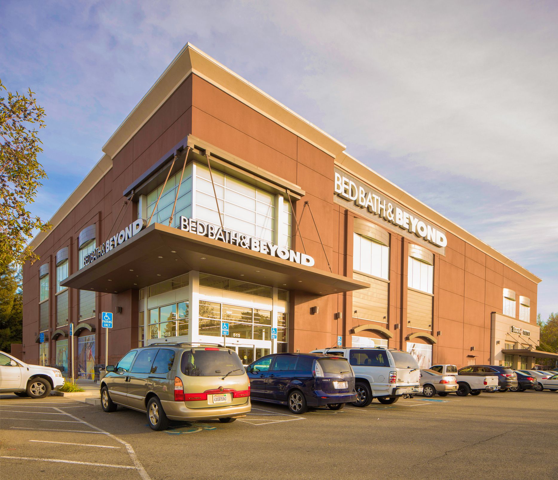 Campbell, USA - December 27, 2016: Bed Bath & Beyond store in Campbell California at sunset with a row of cars parked in front of it.