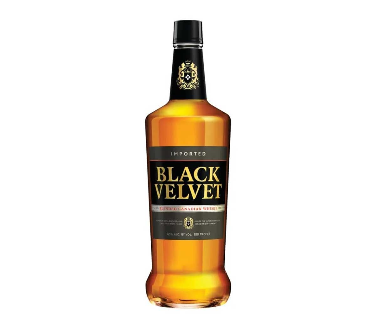 A bottle of Black Velvet Blended Canadian Whisky, often listed among the worst whiskeys, features a black and gold label, clear amber liquid inside, and a black cap, set against a white background.