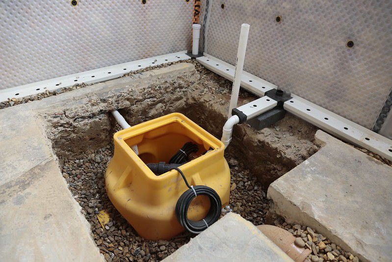 The sump pump and floor drains during installation