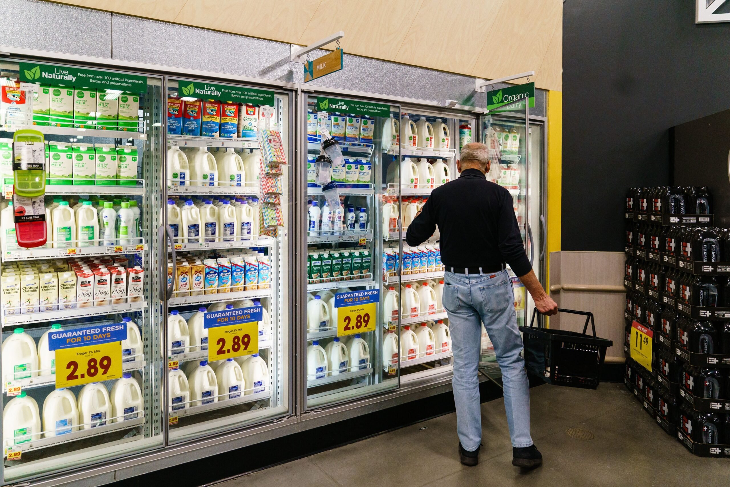 Man shopping in dairy section of grocery store
