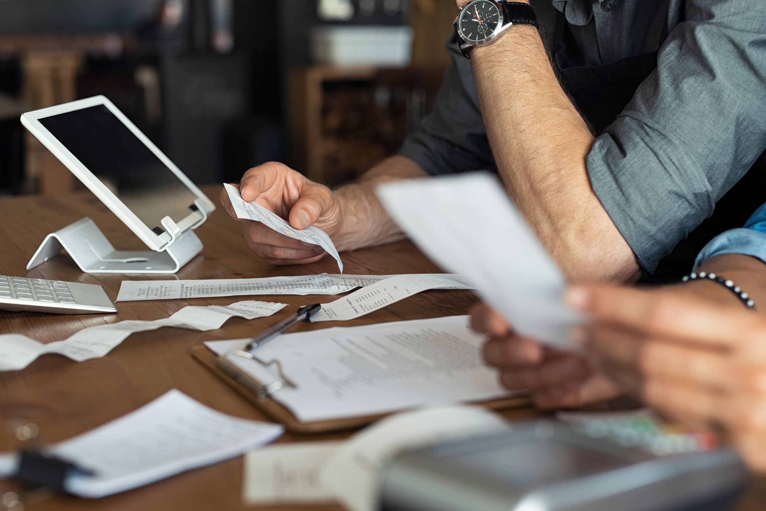 two business owners going over receipts and expenses