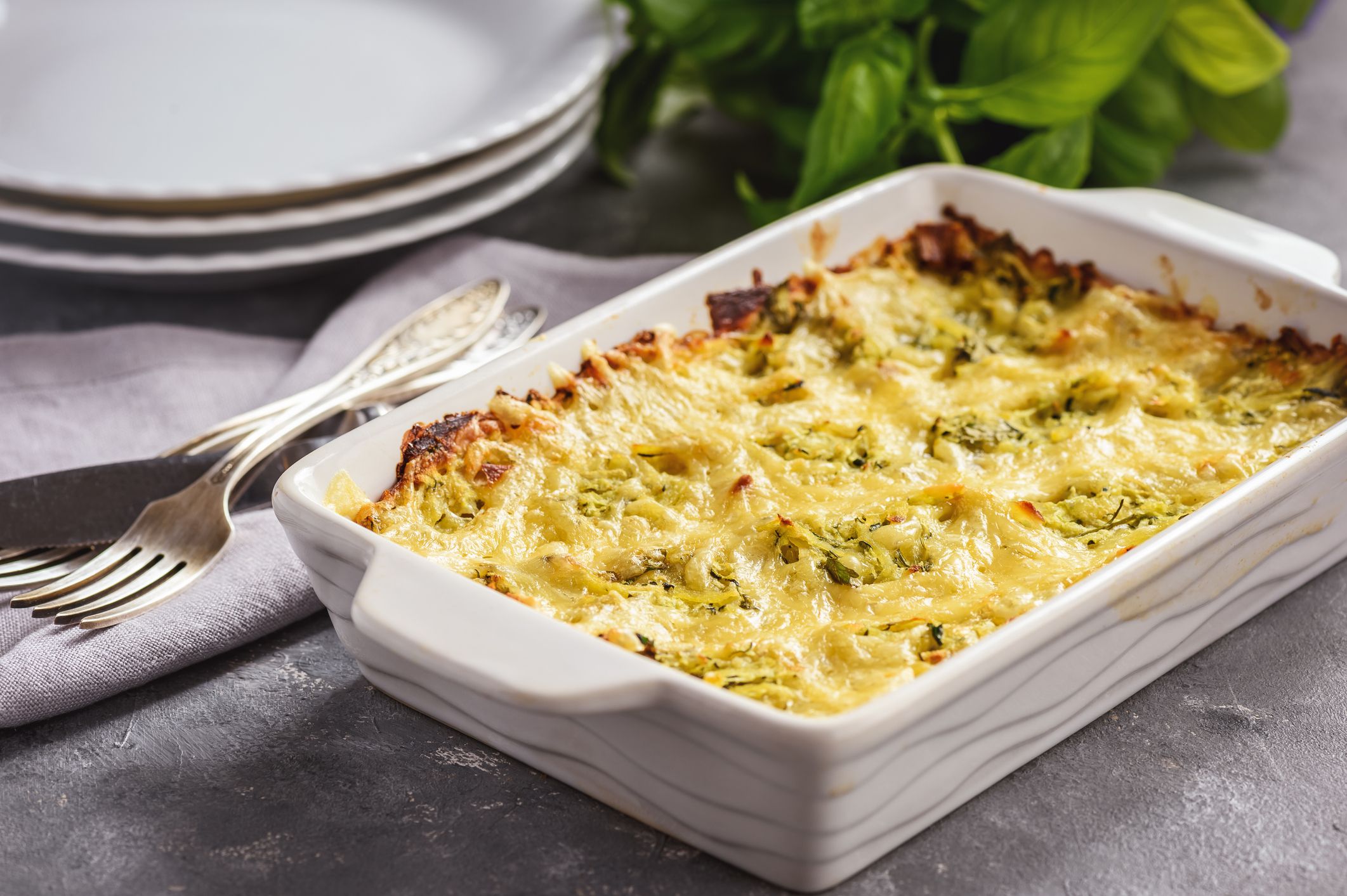 Zucchini and potatoe casserole with cheese, vegetarian food.