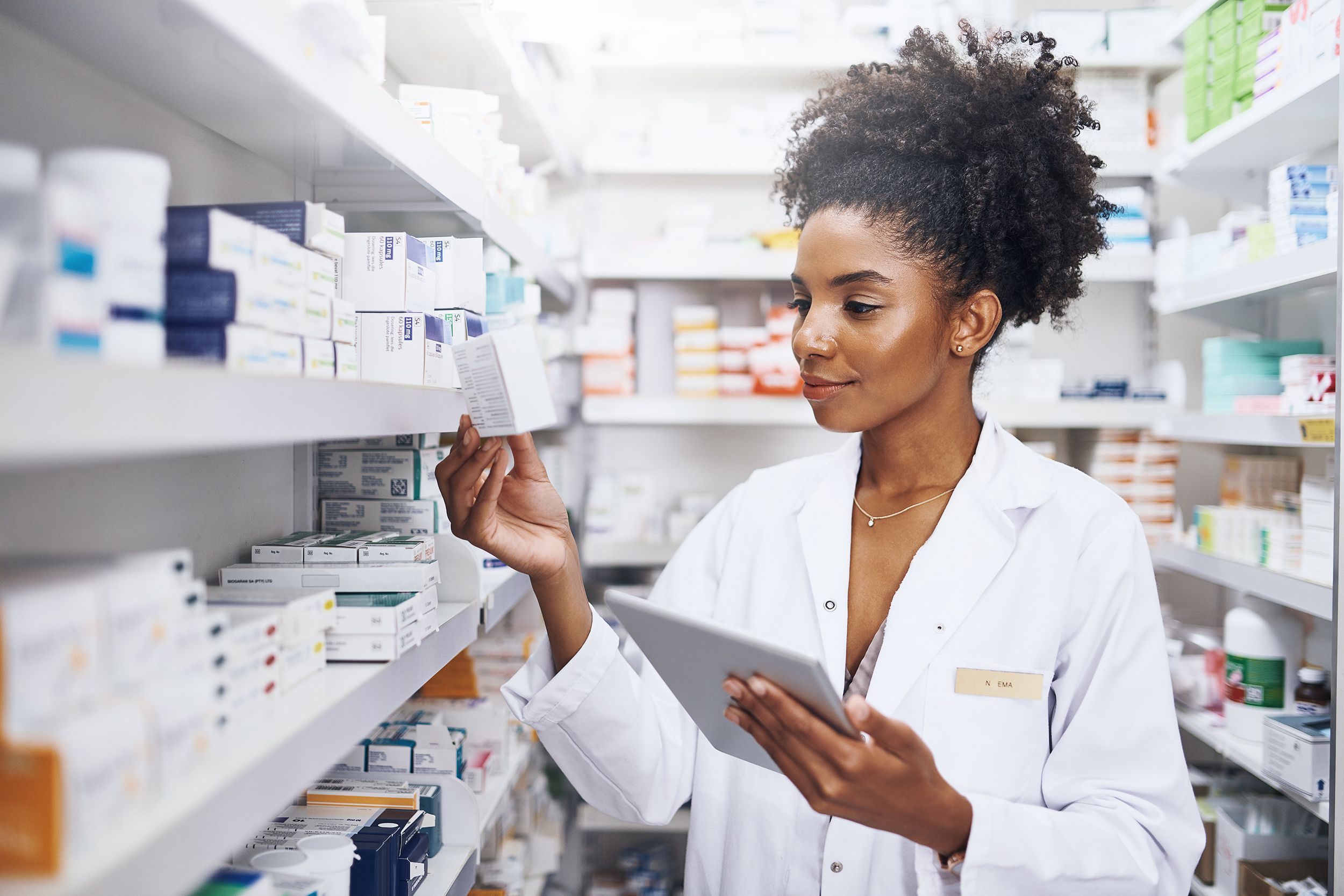 cropped shot of a pharmacist using a digital tablet in a chemist