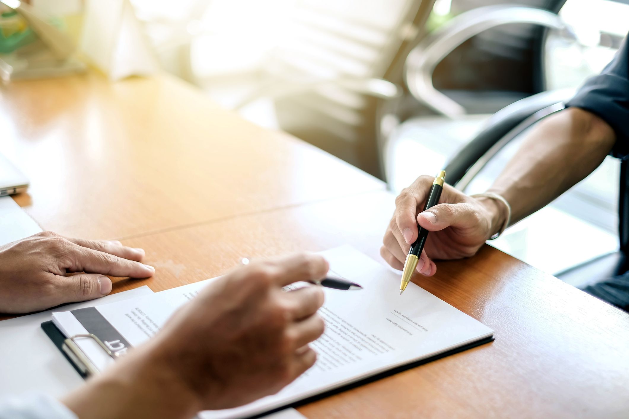 Man signing a contract. Signing an agreement in a document