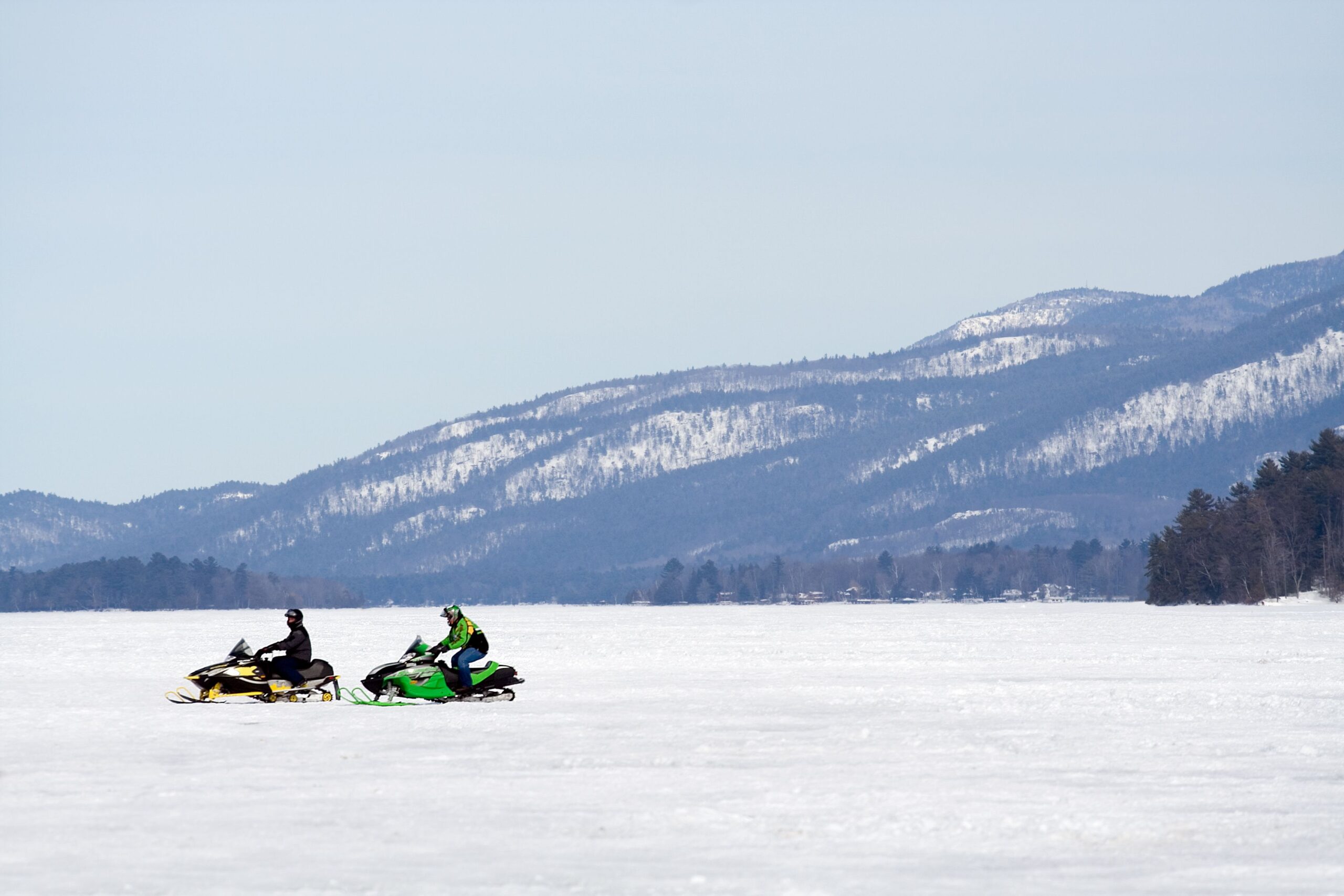 Two lone snow mobiles in the mountains