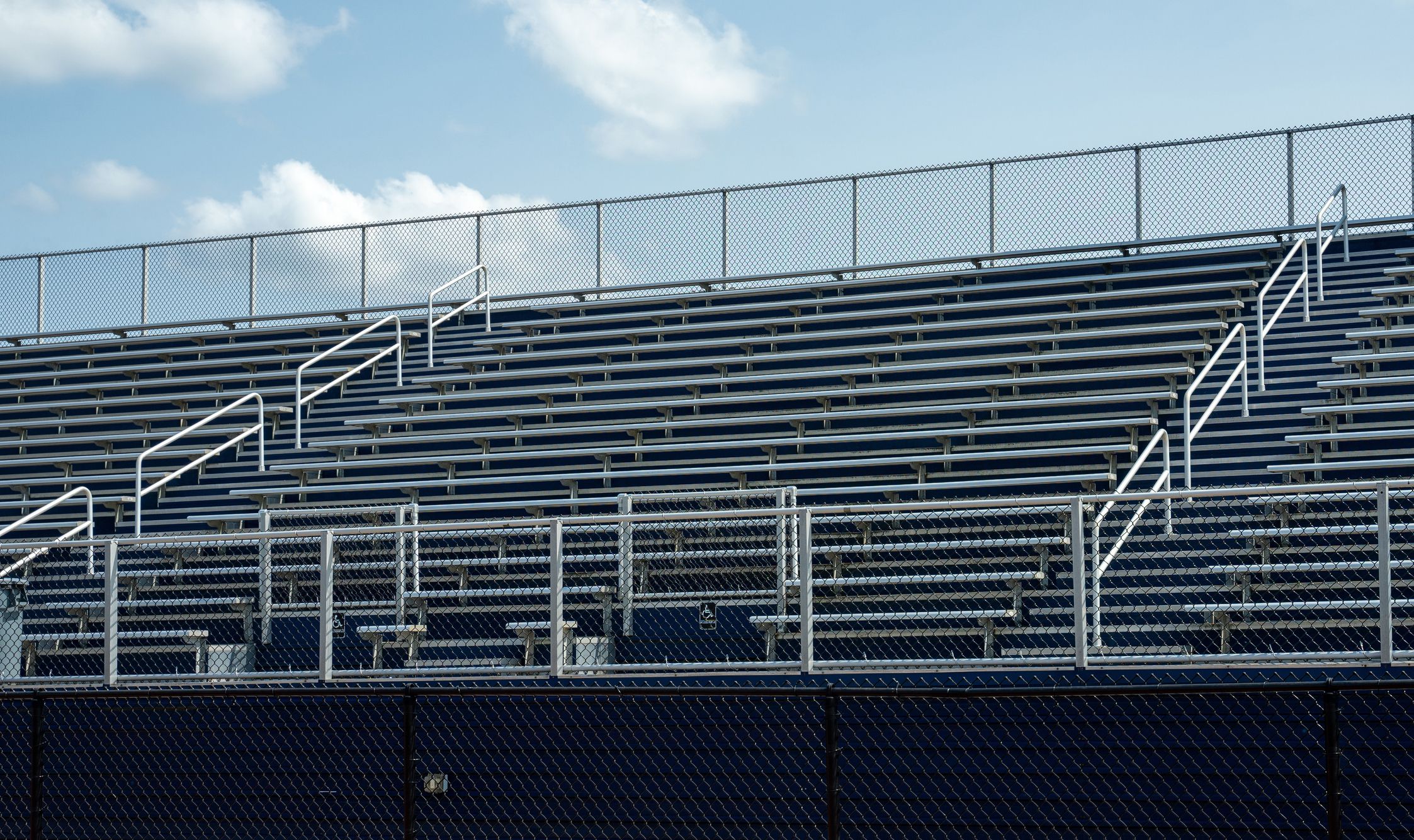 Empty benches in sports stadium. Represents lockdown in sports due to coronavirus.
