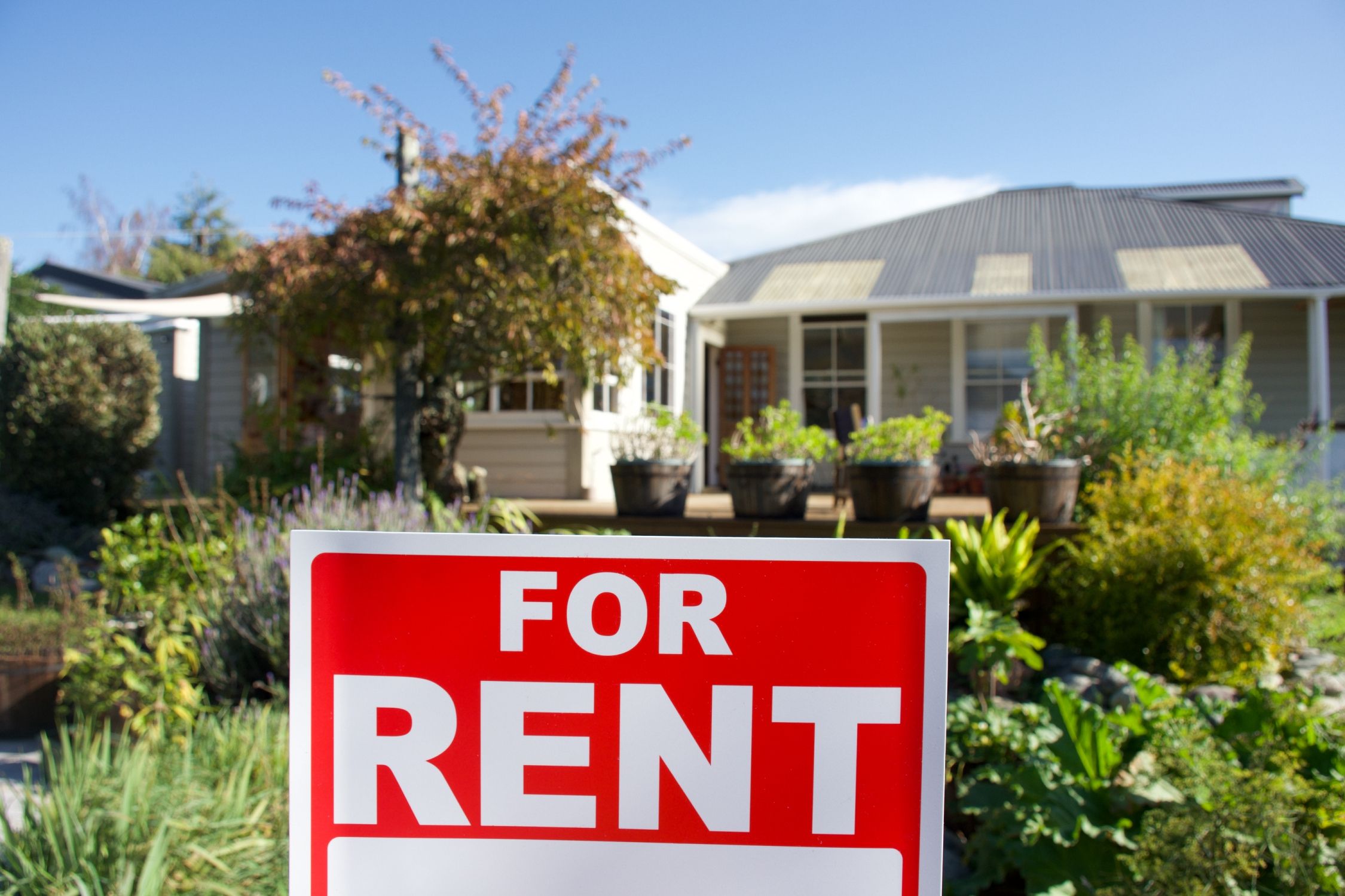 A For Rent Sign Outside a House.