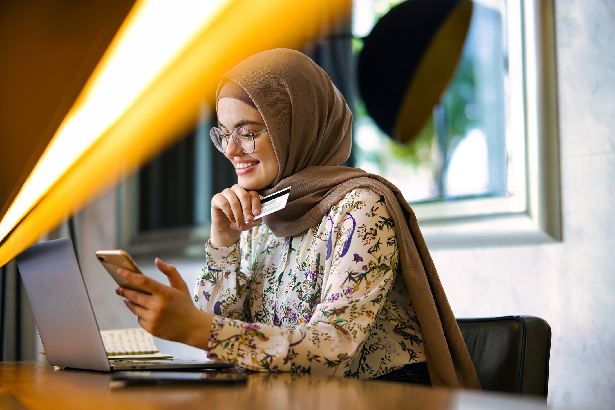 Girls shopping online using credit card and a smartphone